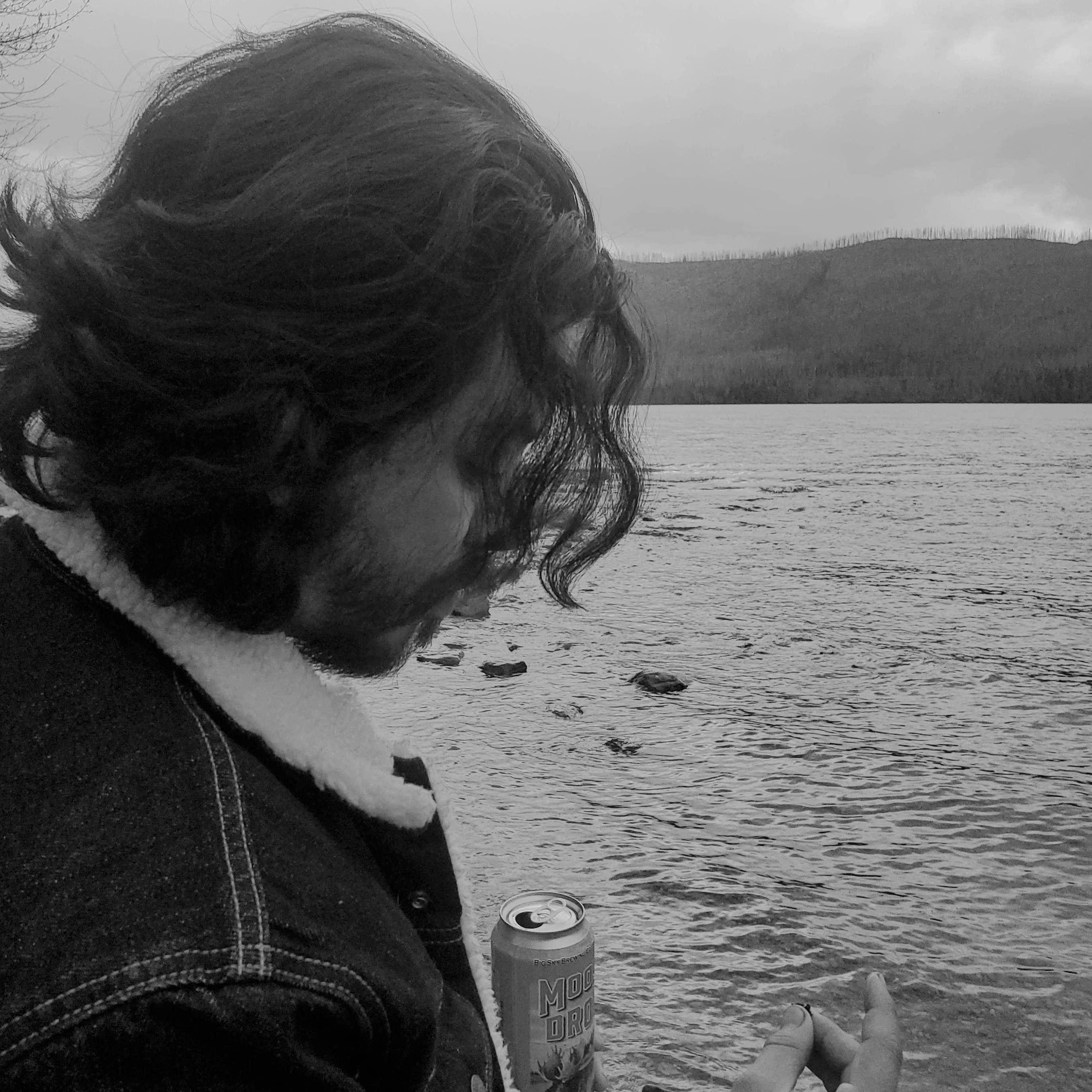 Chris examining pebbles and asking me if they are sapphires - Lake McDonald, Glacier National Park, May 2022