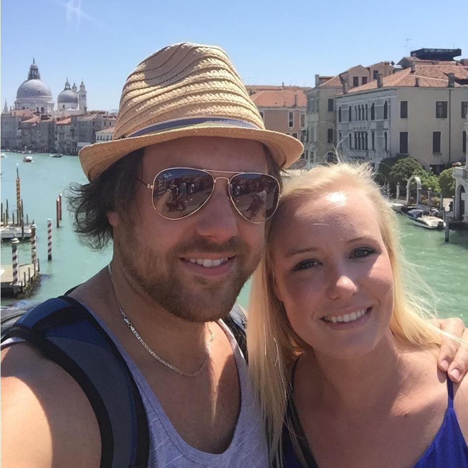 Standing on one of the many bridges over the Grand Canal in Venice, Italy.