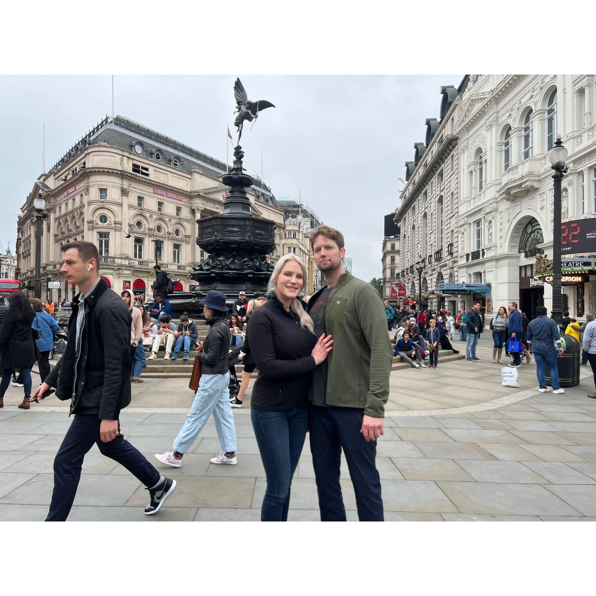 June 2022 - London, England - In front of the Piccadilly Circus fountain.