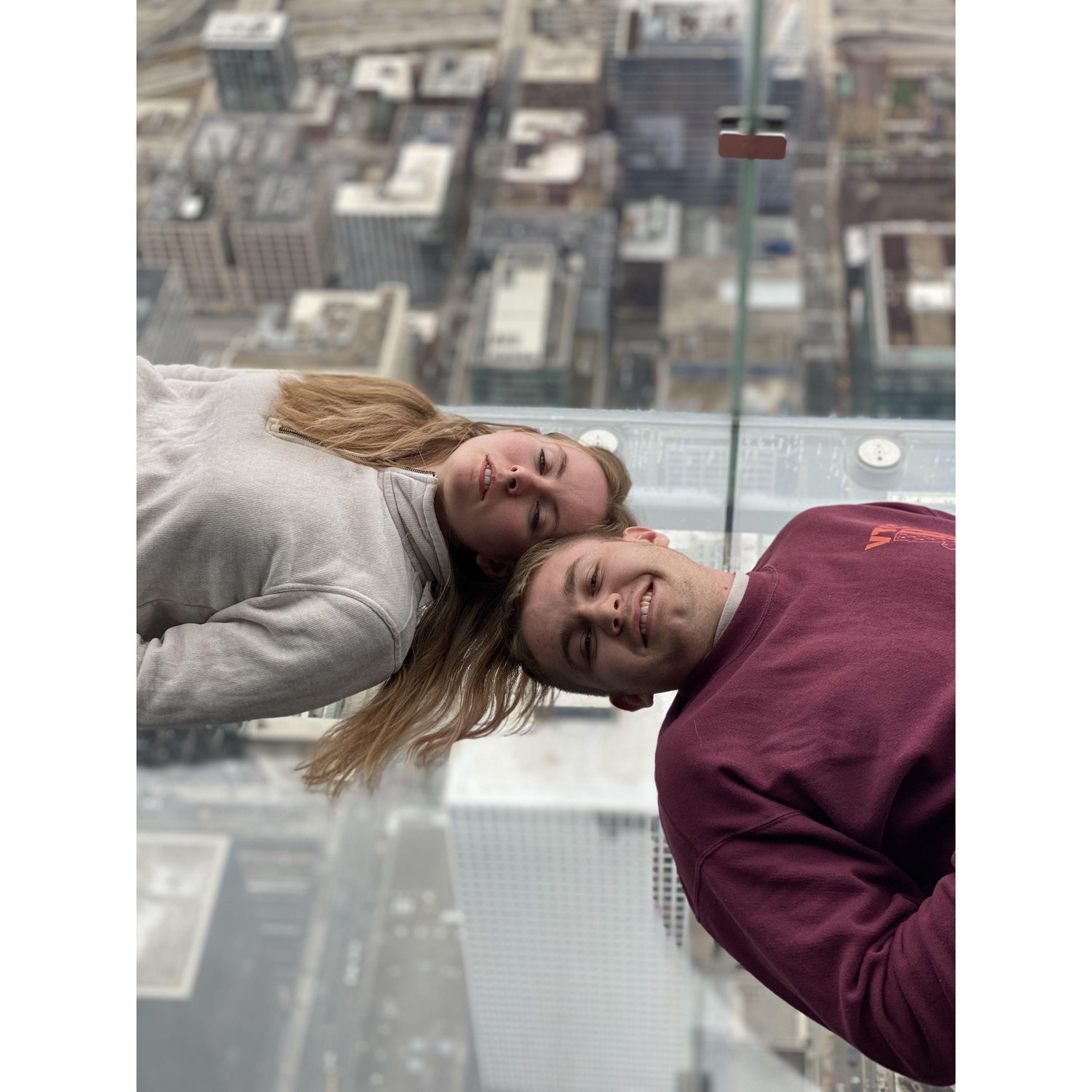High above the ground in the Willis tower. They built clear boxes over the side looking strait down, Nick was shaking!