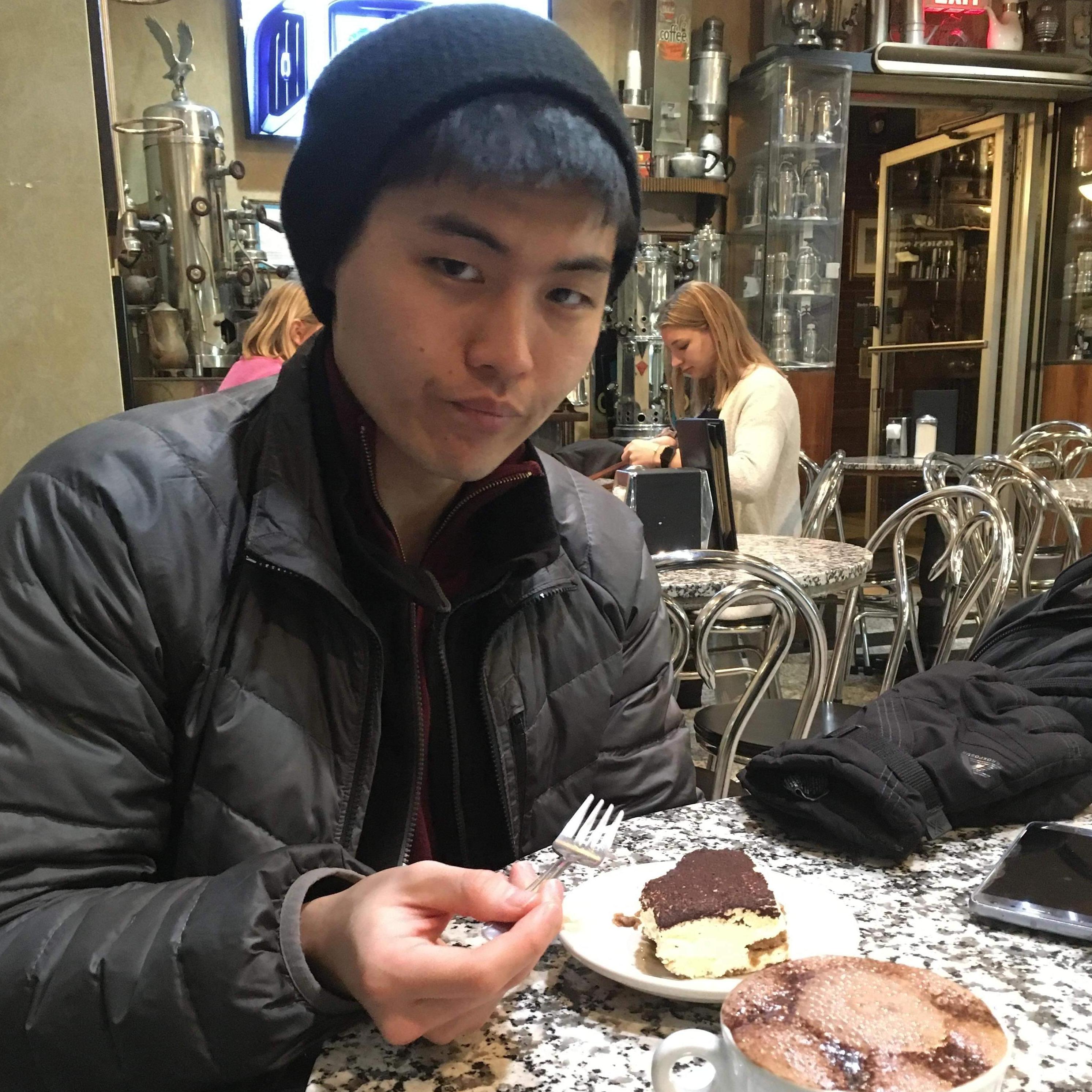 Yong is busy devouring Tiramisu. We attended a concert after this: Bach's cello suites on violin (02/12/2020, Victoria's Cafe, Boston, MA)