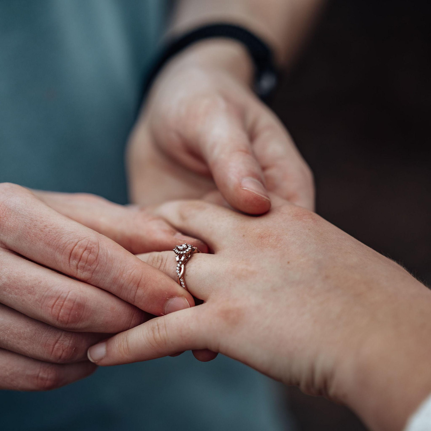 Alex putting the engagement ring on Camille