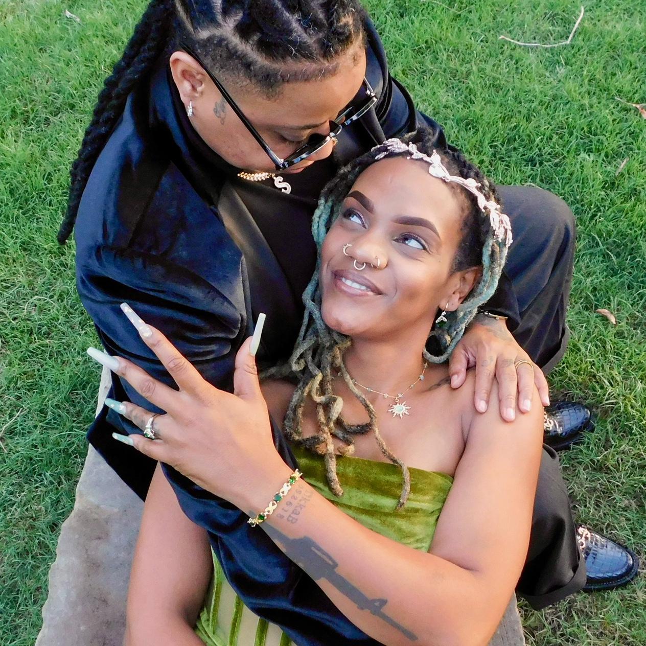 A tender pause on stone’s embrace—two souls entwined, sharing a quiet spell of love and connection.