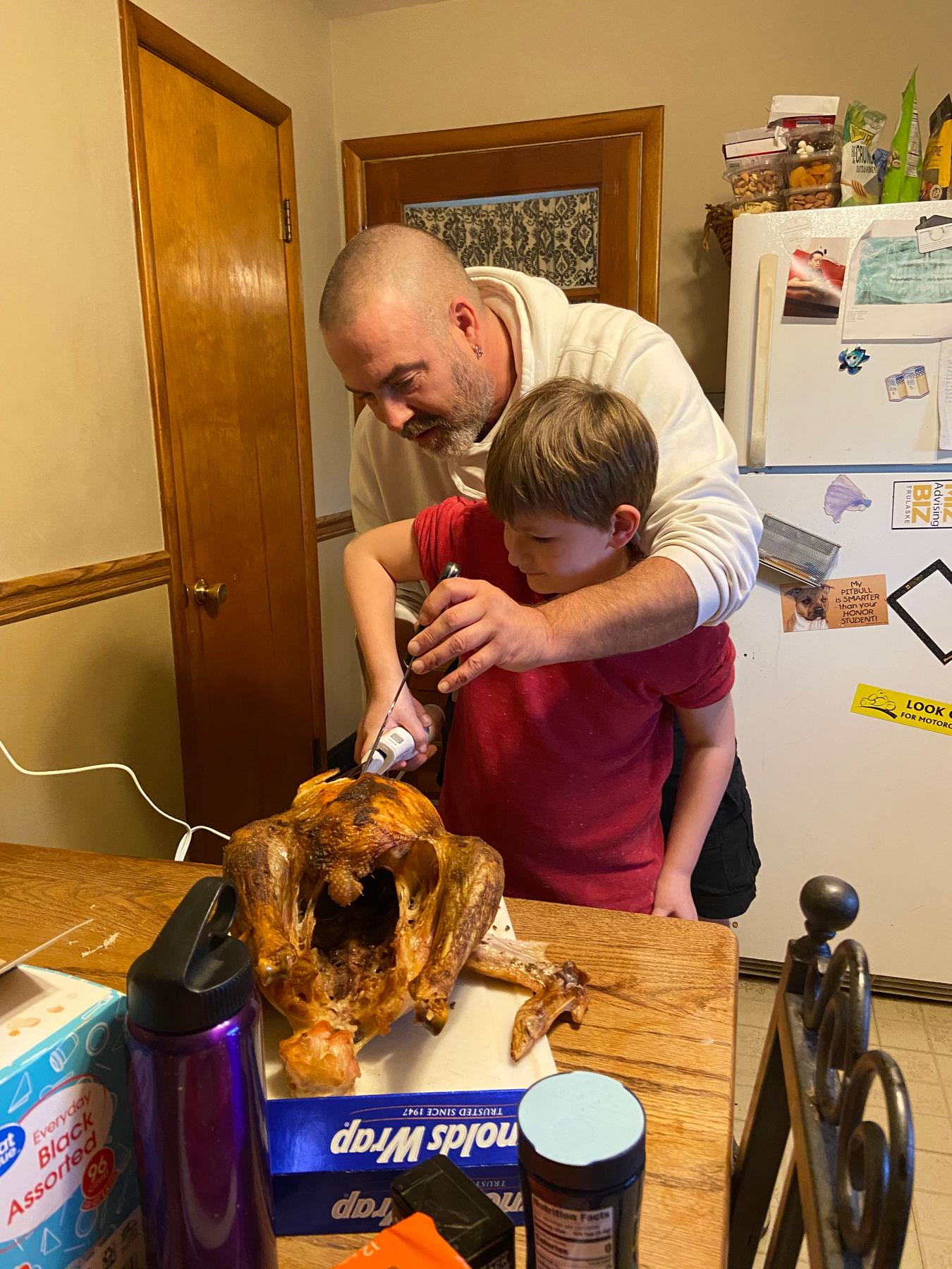 December 2020 - Matt & Xavier carving the turkey