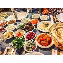 Visit an arab restaurant where you will typically be greeted with a starter of many different types of salad and pita.