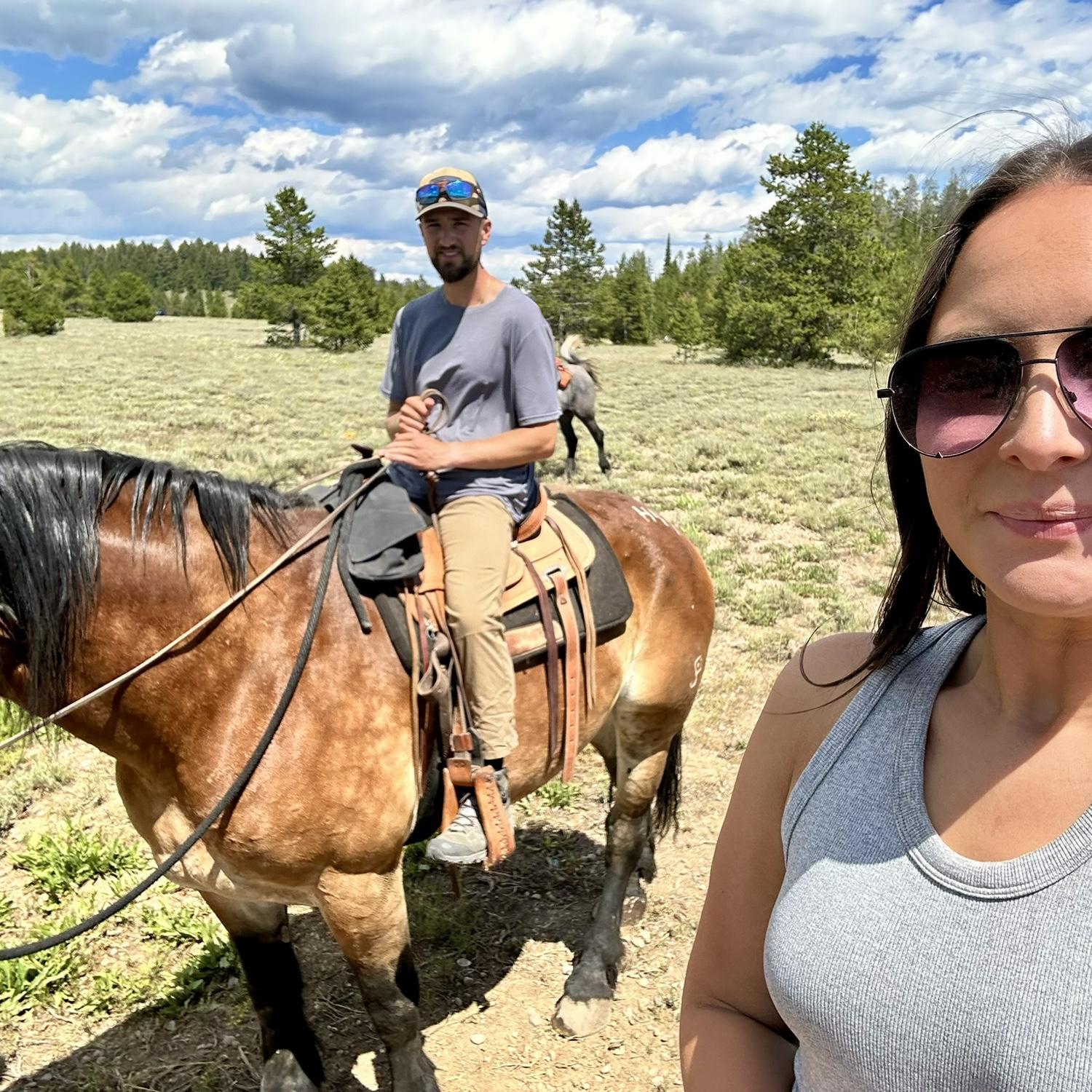 James and Emily horseback riding through Grand Teton National Park, WY