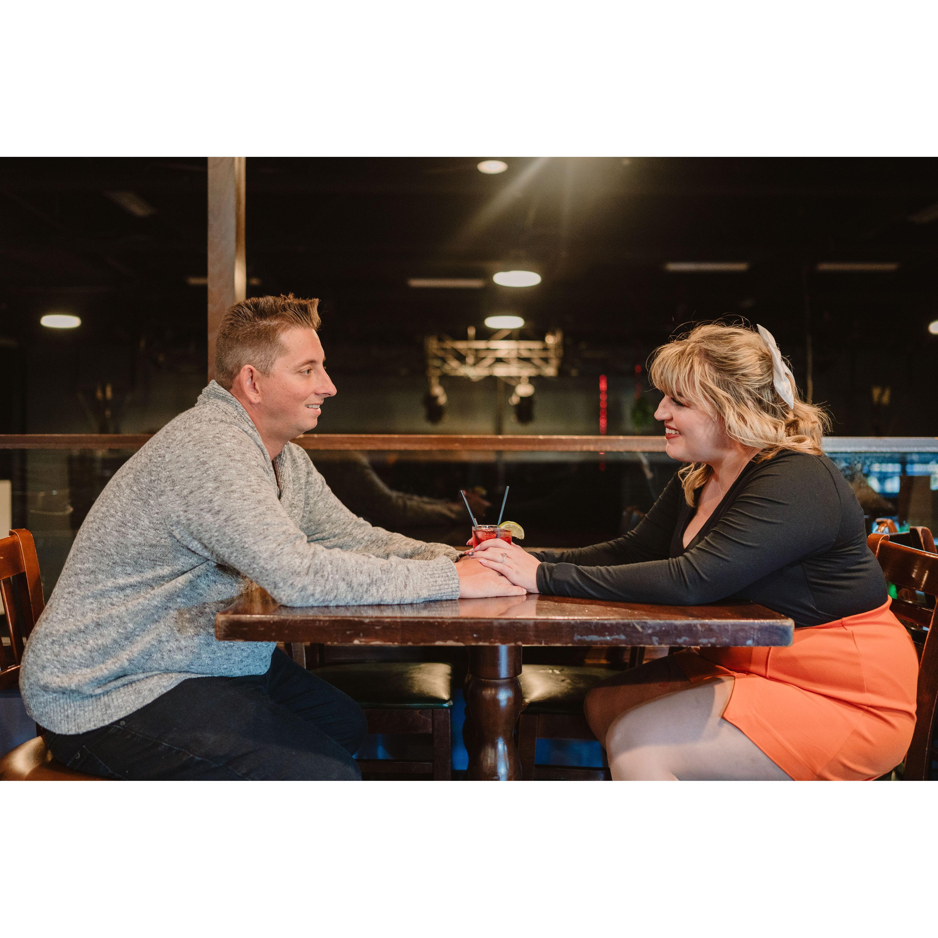 One of our engagement photos taken at the table where Eddie first saw Samantha from across the room