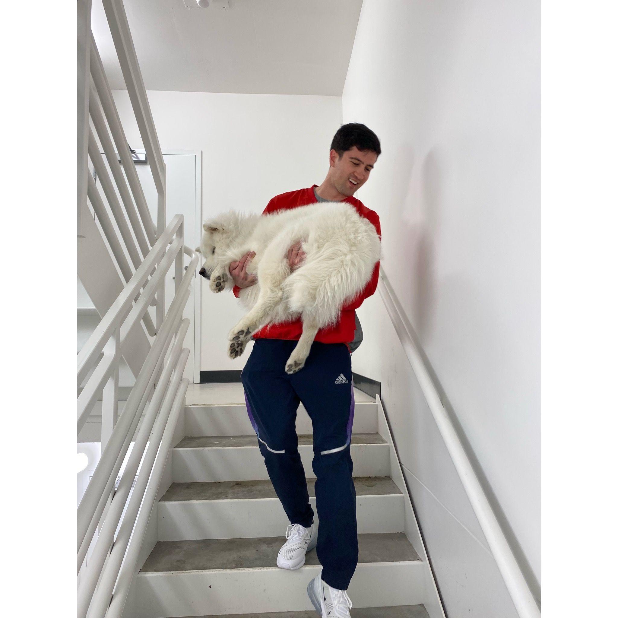 Richard carrying Hero down the stairs during a fire drill