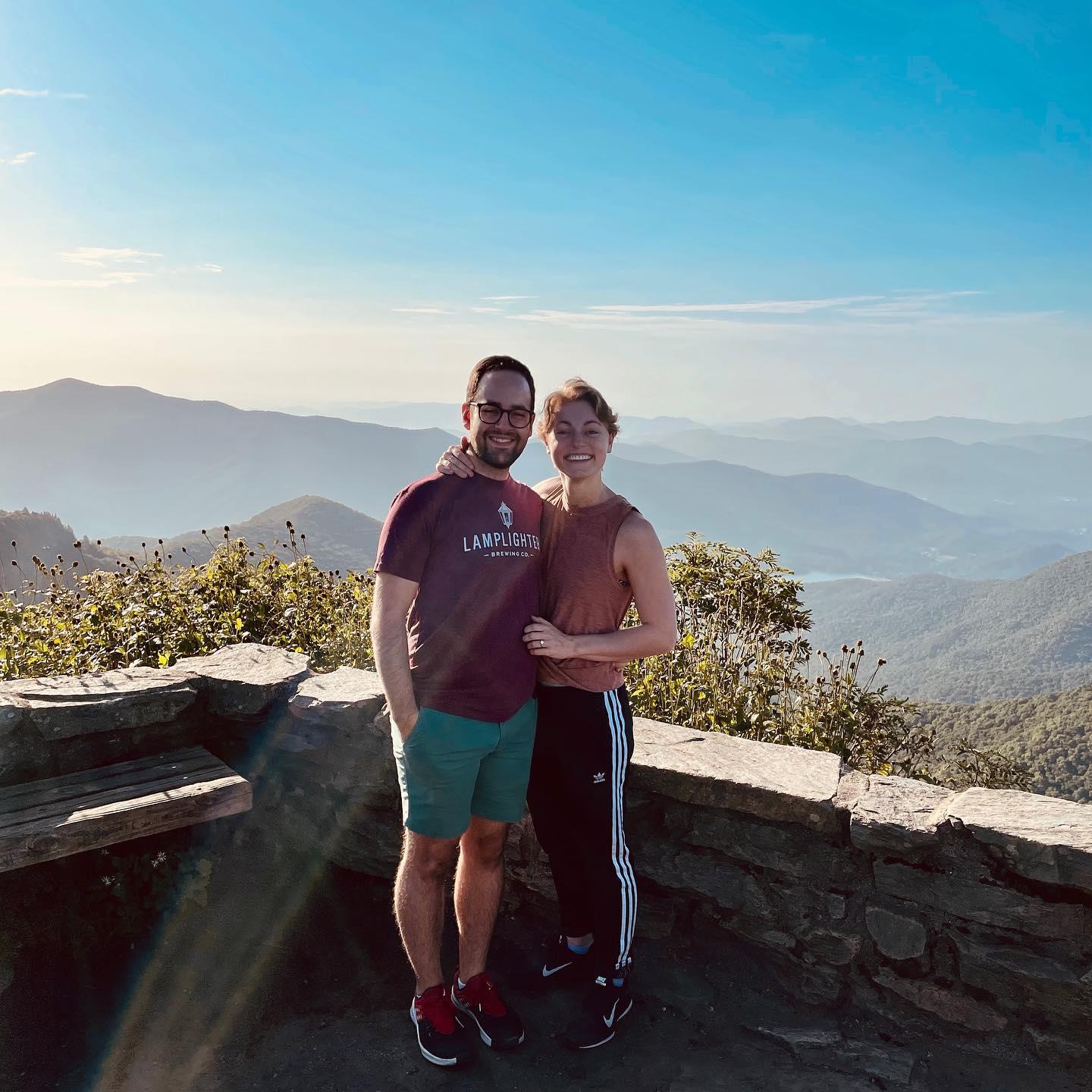 Right after he proposed, we hung out here for a while. We watched the sun rise and burn off the fog that had settled in the surrounding valleys overnight. Another hiker came by and took this pic!