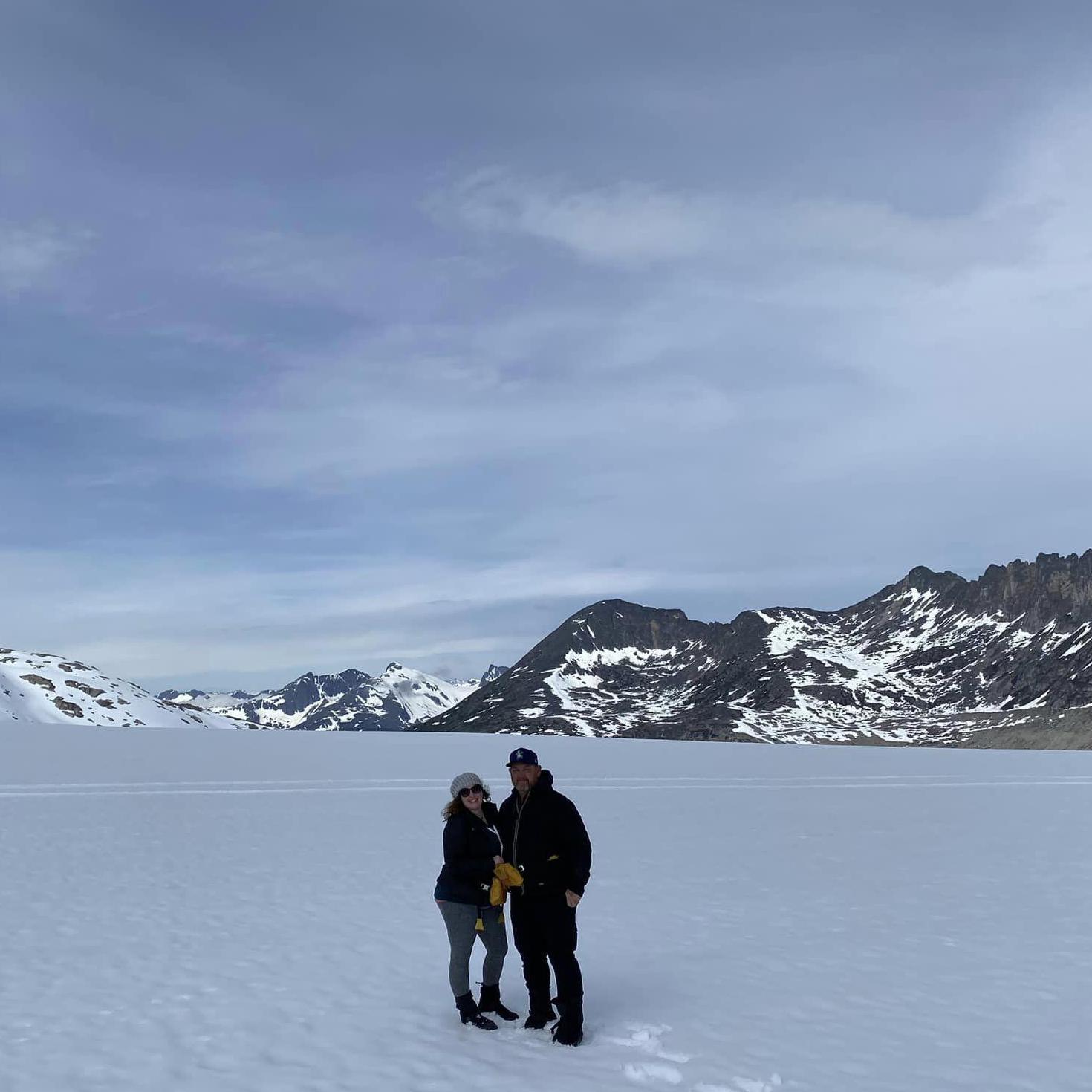We love to travel! Here's us in Alaska during a dog sled ride!