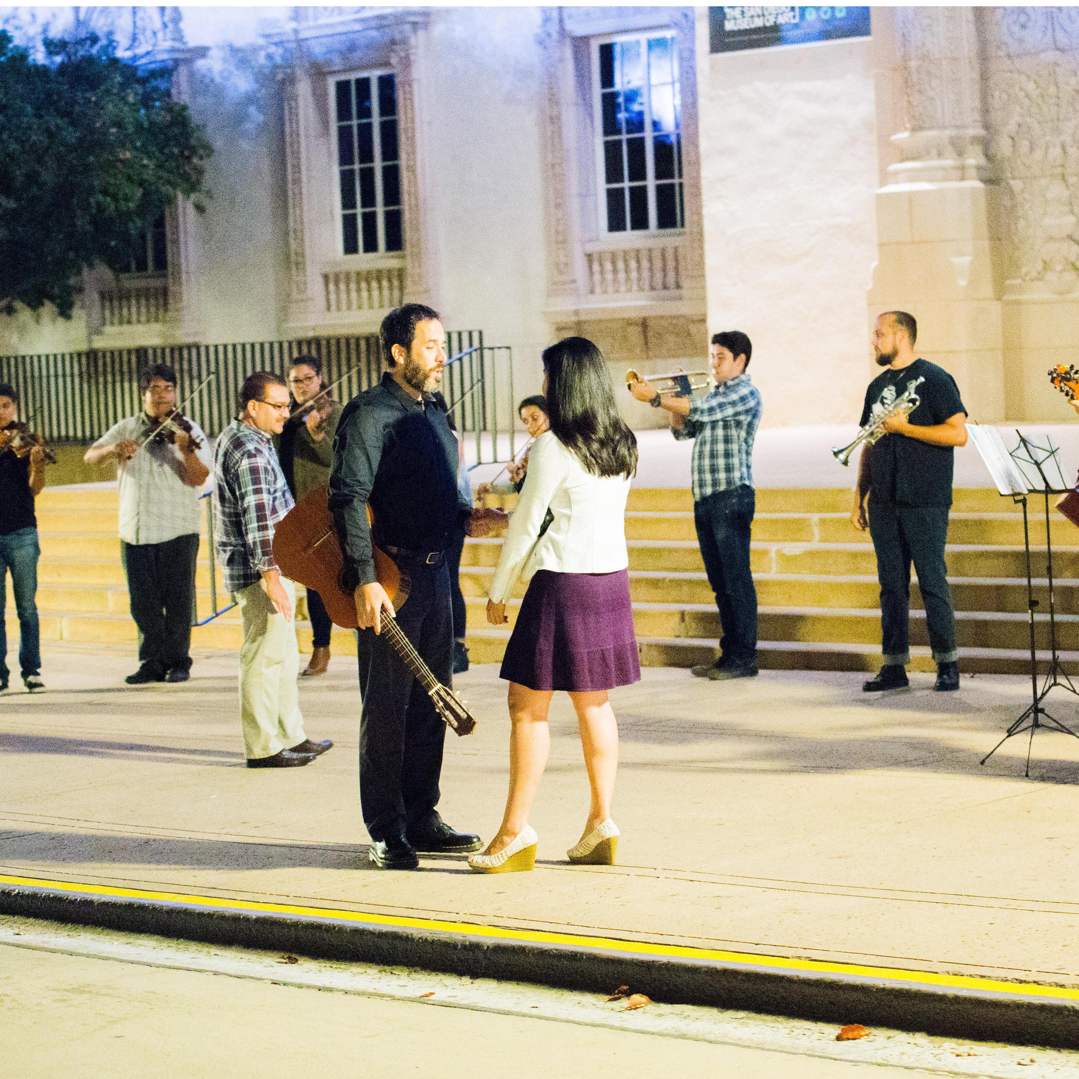 Alex serenading Liz with a mariachi band