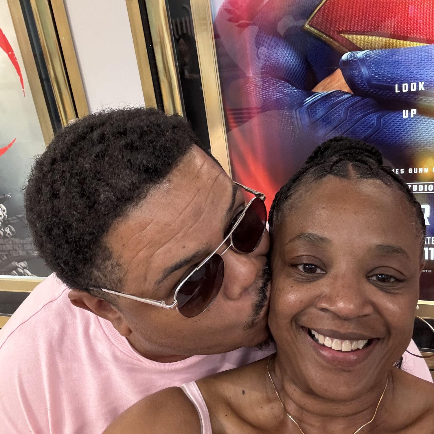 The beginning of a trend.  The cheek kiss is inevitable for every selfie.