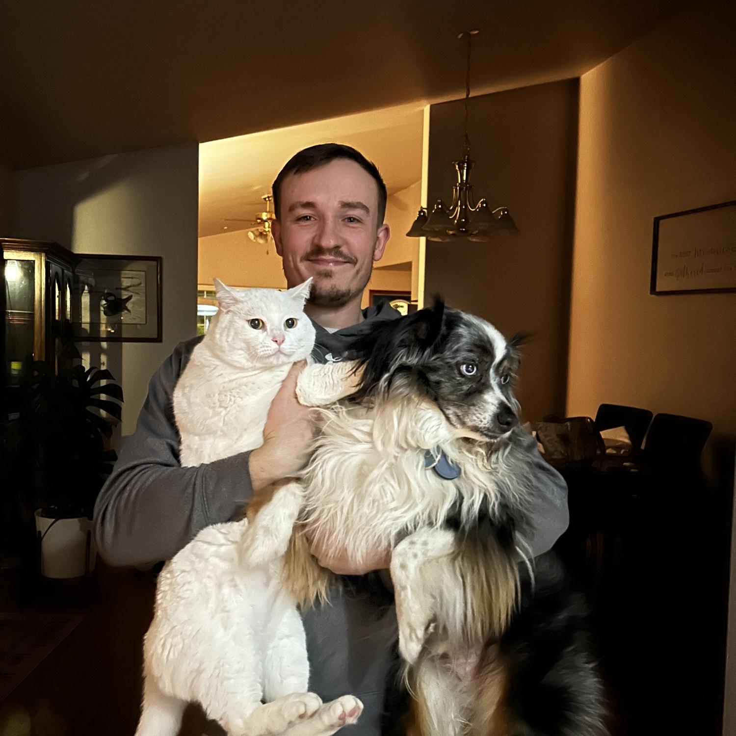 One of the many variations of mark holding our fur babies! This specific one is of Louie our cat, and our mini Aussie Suede