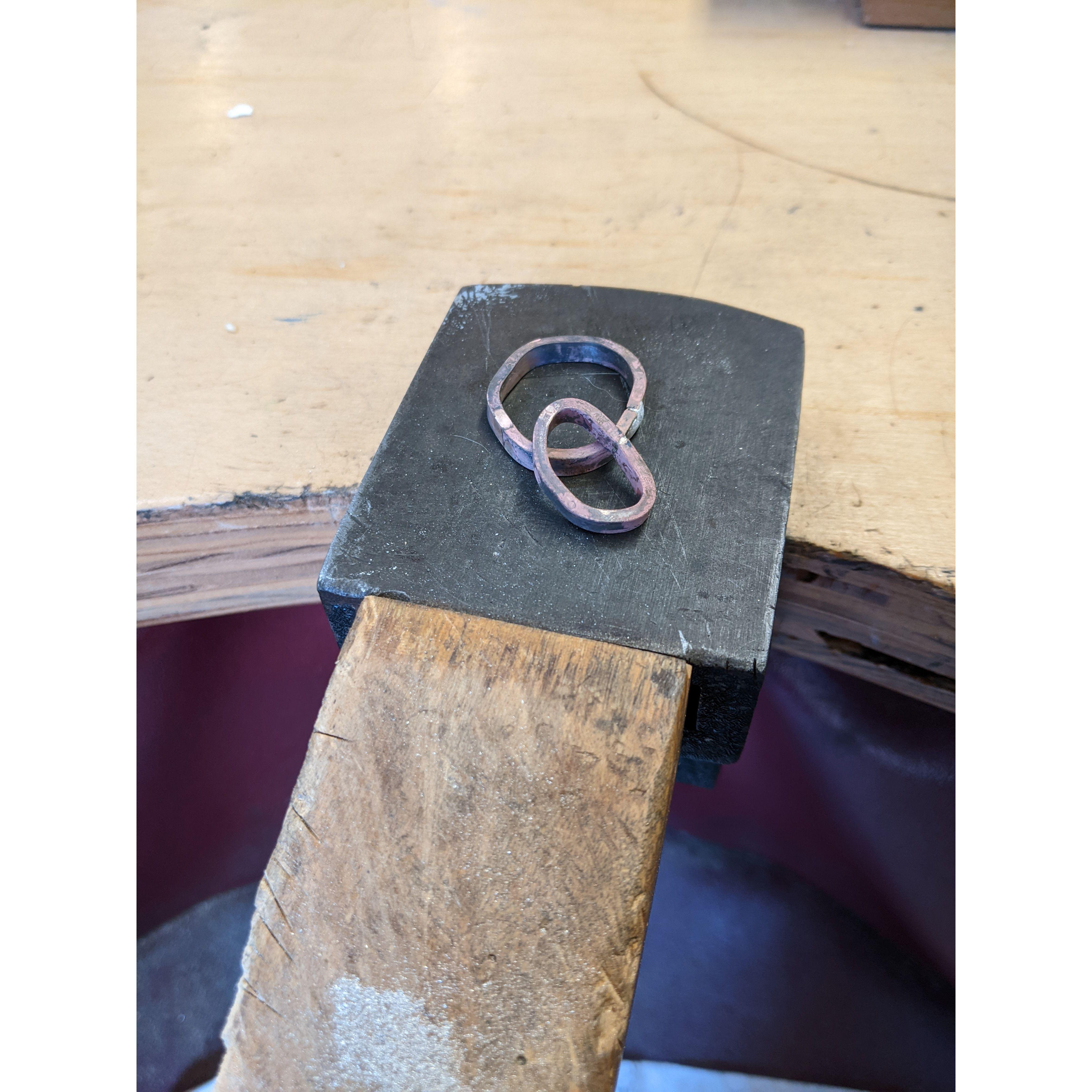 The metal started as ingots of white gold, which were pulled into a circular shape and soldered at the open ends.