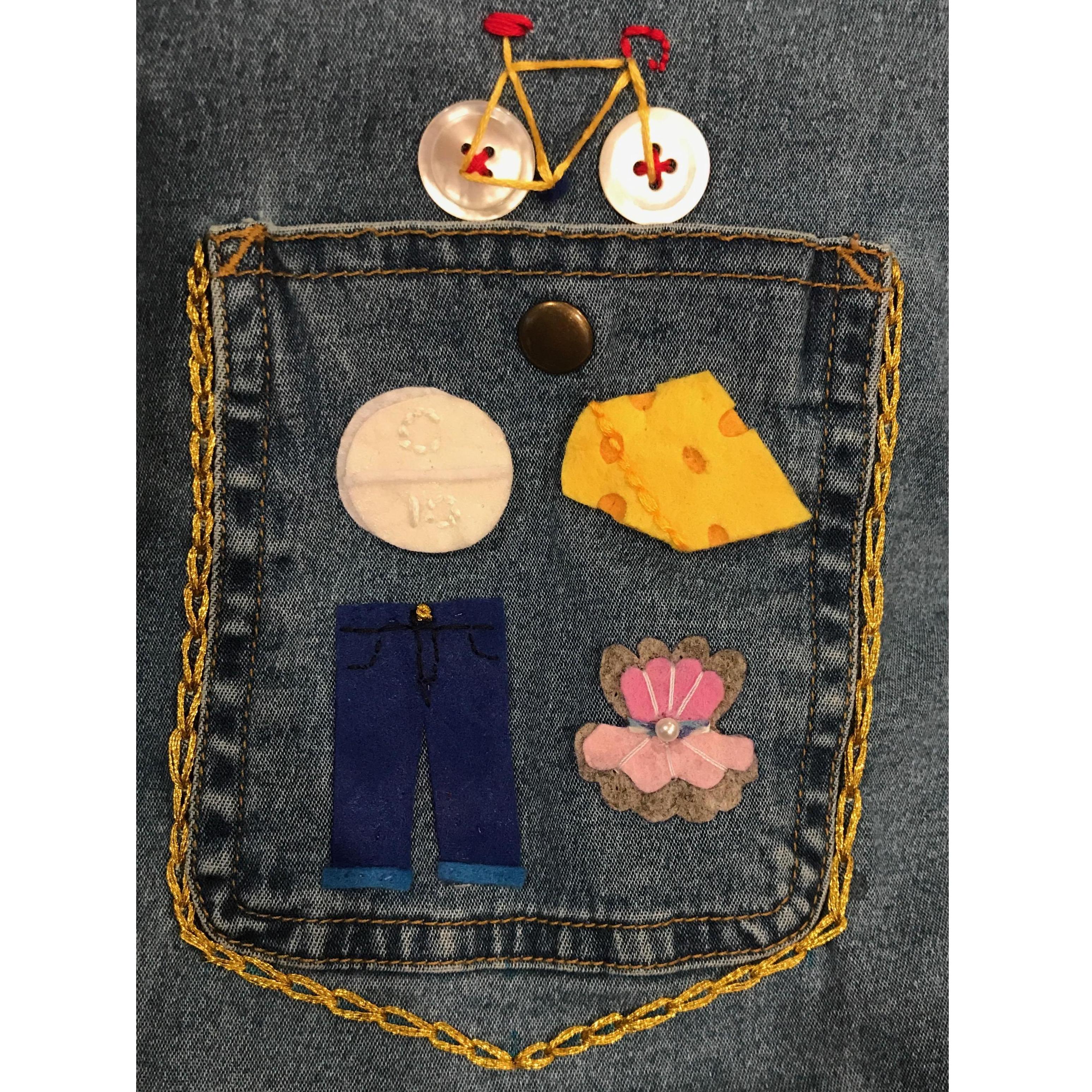 Our crest, as embroidered by Hillary in Dec 2018: bicycle, Claritin (Jake had a cat when we met, Hillary is allergic), cheese, thrifted Levi's, oysters.