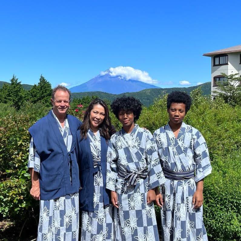 We are in "yukata", paused in front of Mt. Fuji — timeless moment in Japan.