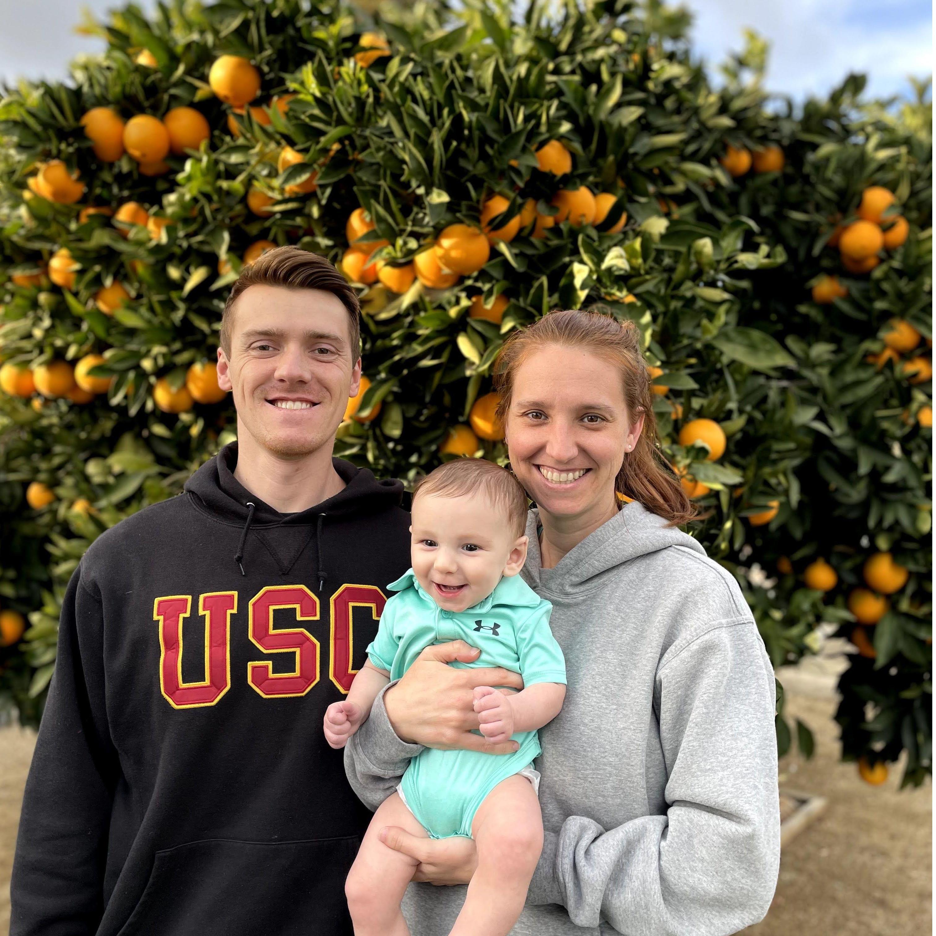 Traditional sibling picture in front of the Carmichael orange tree featuring baby Hudson!