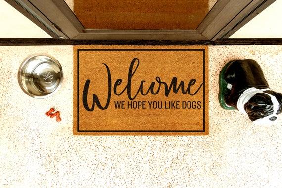 MUST LOVE DOGS | Welcome...We Hope You Like Dogs Brown Doormat | 2 Designs | 4 Sizes | Customizable | Natural Coir | Non-Slip Backing