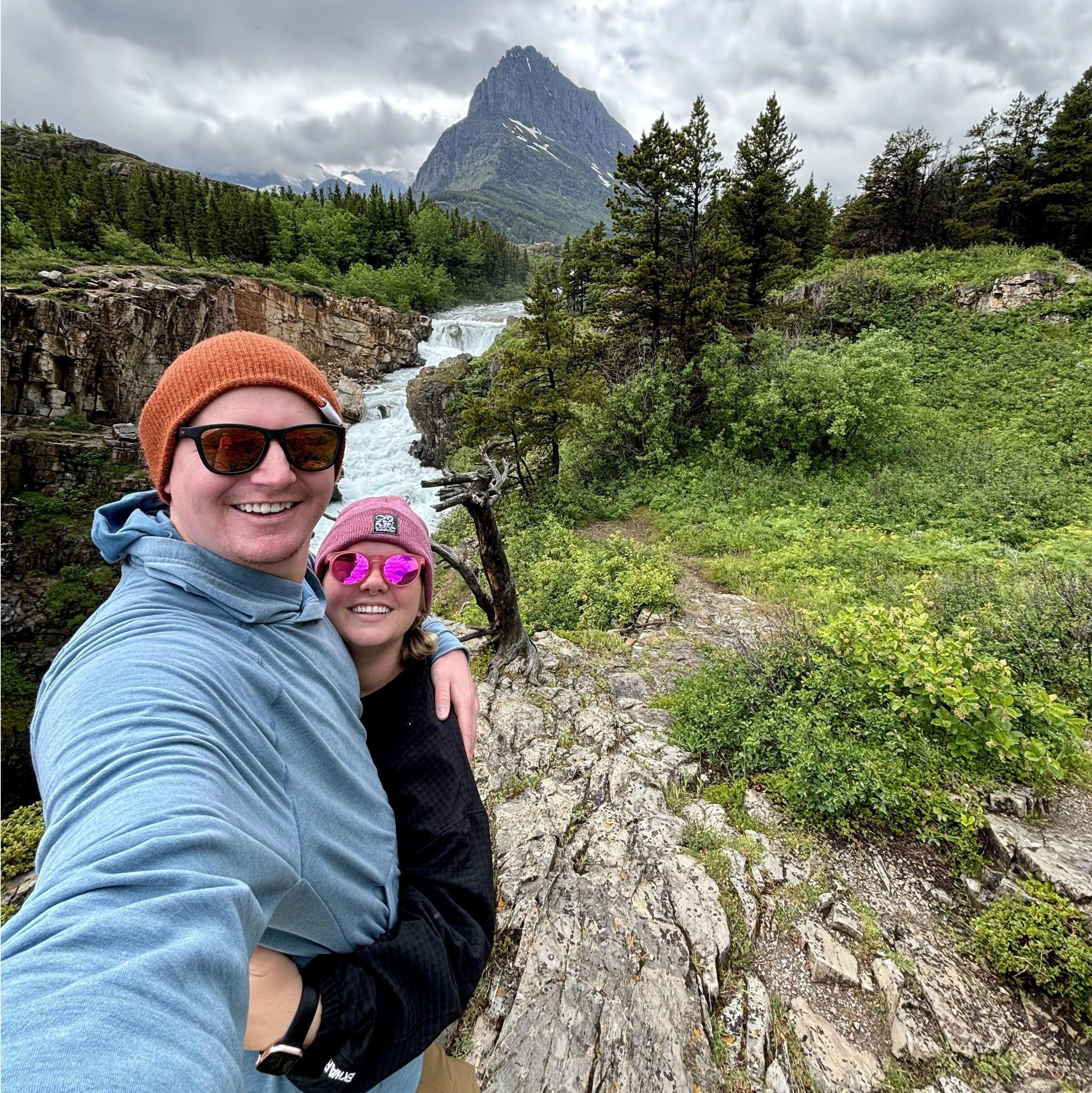 Smiles after braving 60 MPH wind gusts in our tent in Glacier National Park