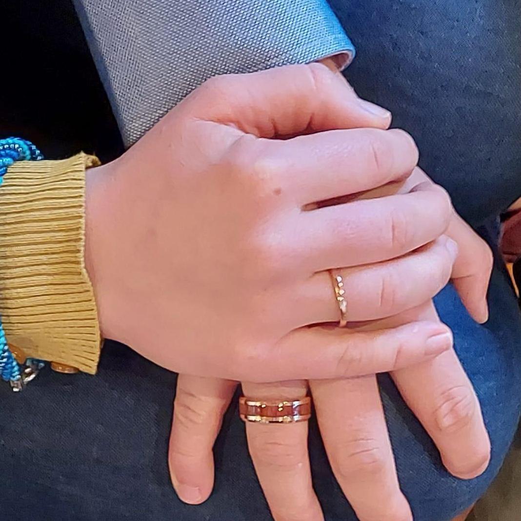 Our wedding bands are both matching rose gold. Ben's ring has an acacia wood center, like the trees that we climb after drongos in.