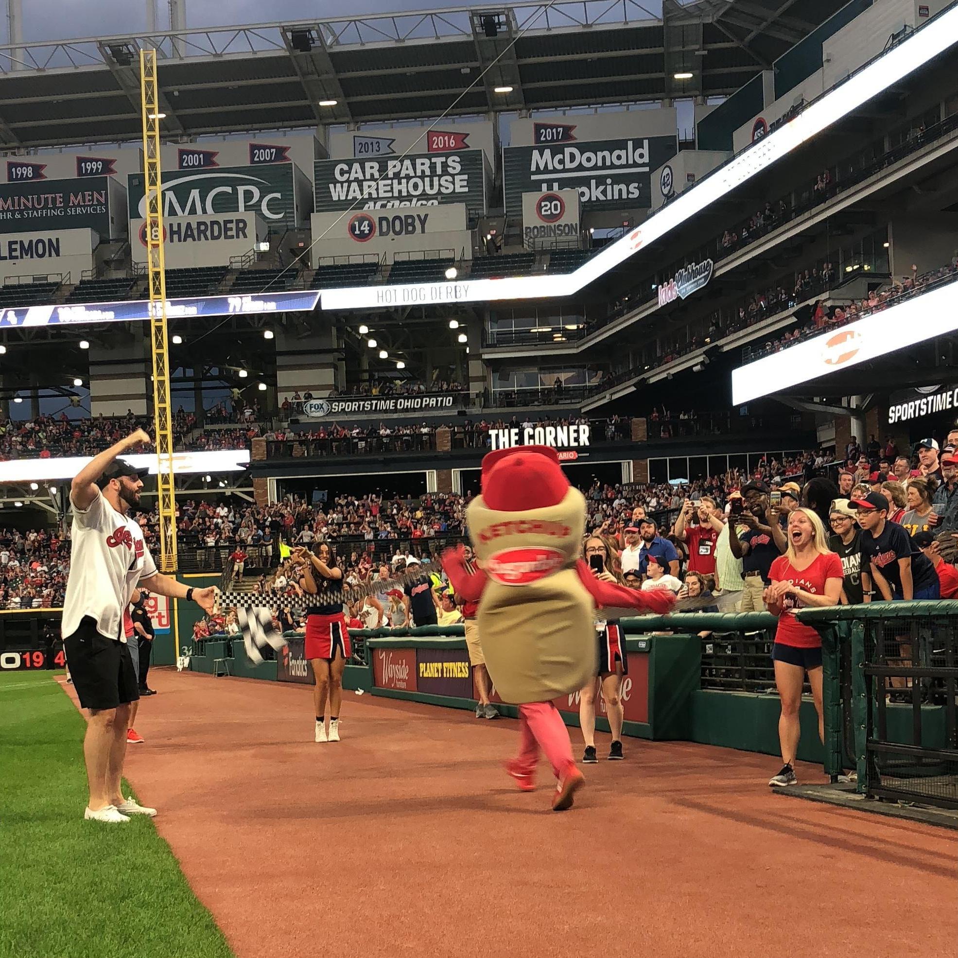 Holding the finish line for the Cleveland Indians hot dog race