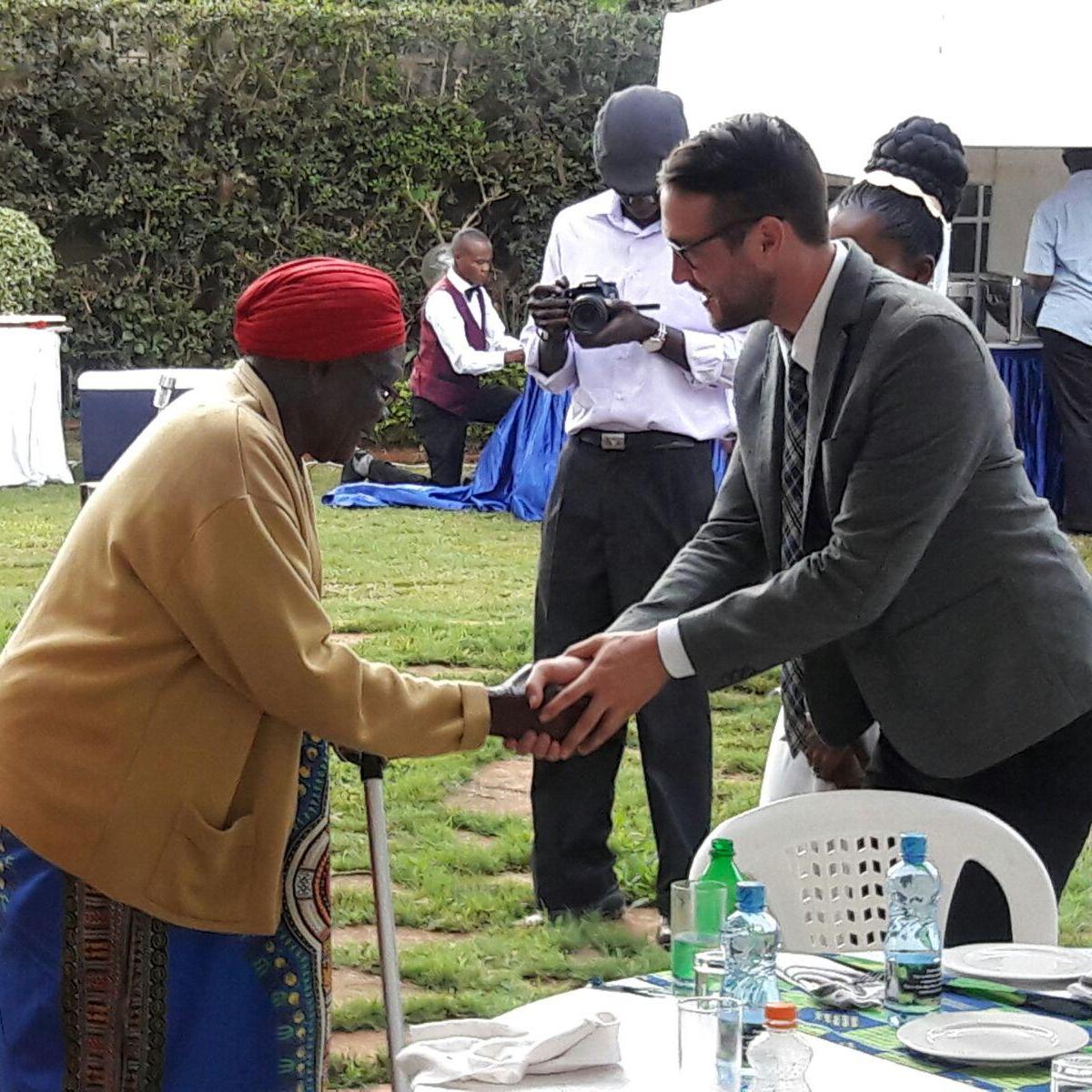 Christopher receiving a hand of blessing from Irene's grandmother ; Turfena Okech. #ohhappyday