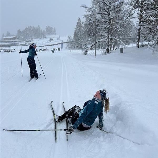 Makenna after falling right after getting our skis from the rental shop in Austria, Alex laughing in background.