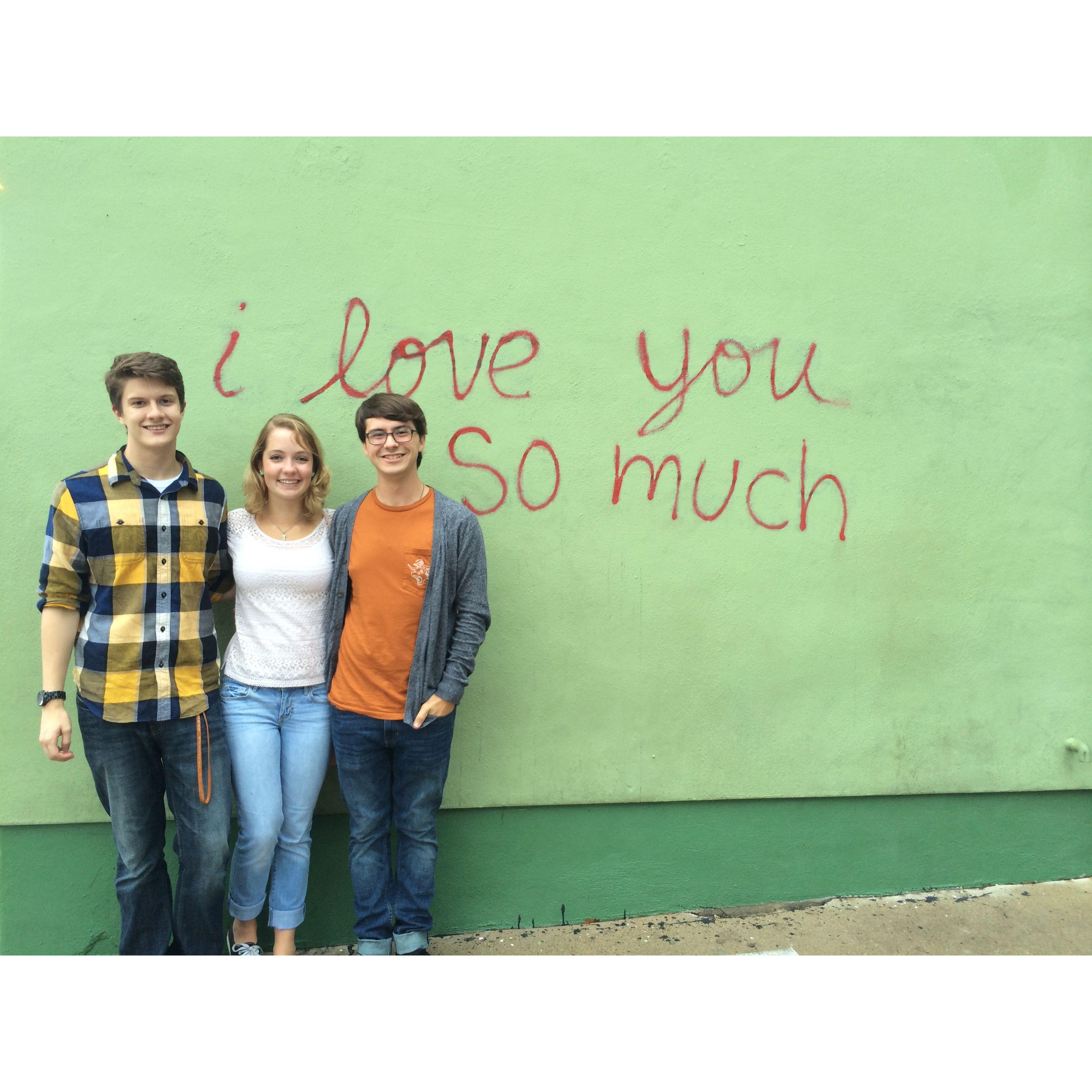Our very first photo together, taken in 2014 after a day of exploring downtown Austin together. It appears the wall knew before we did...