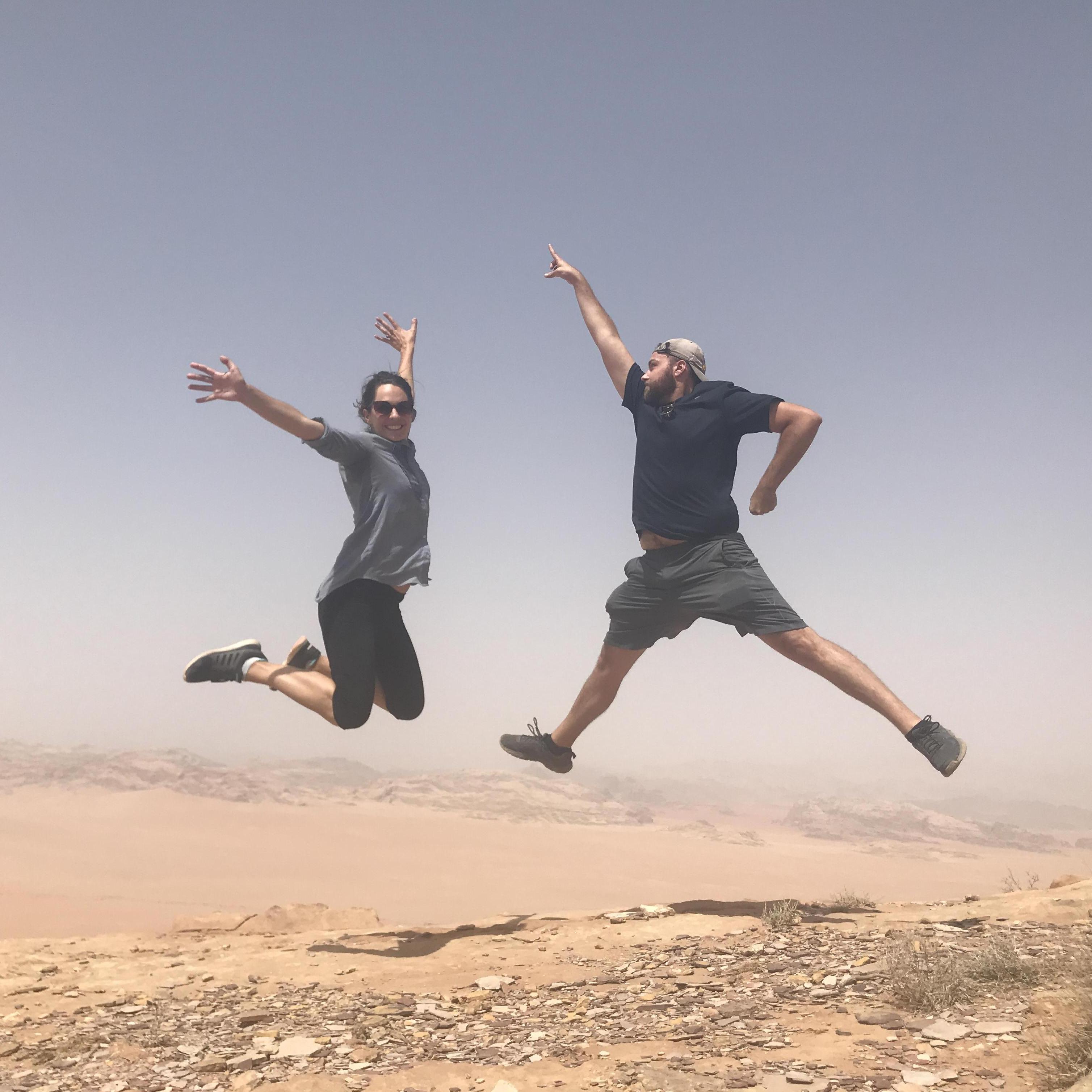 Leaping off of sand dunes in the Wadi Rum desert, Jordan
