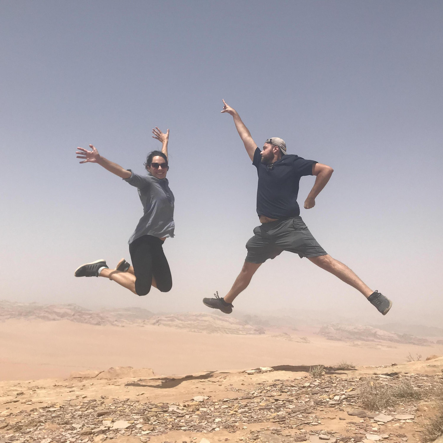 Leaping off of sand dunes in the Wadi Rum desert, Jordan