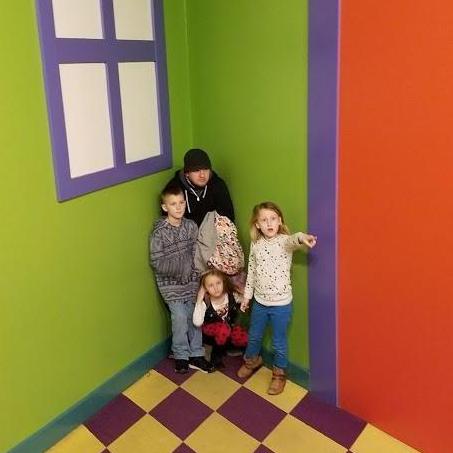 Chris, Andrew, Sophie, and Lilly looking smol at Entertrainment Junction's Fun House.