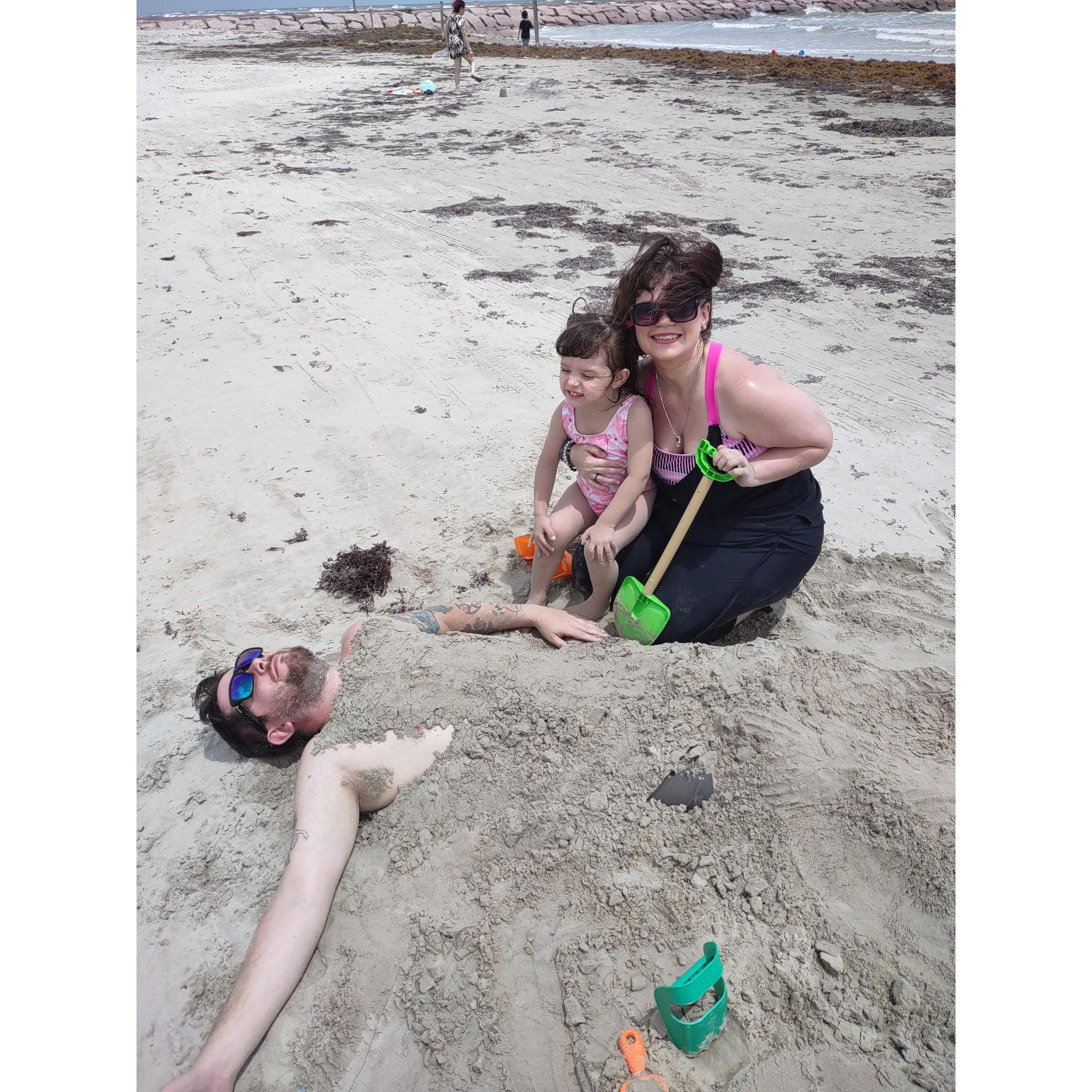 Mom + Alora buried dad because he forgot to bring the sunscreen.