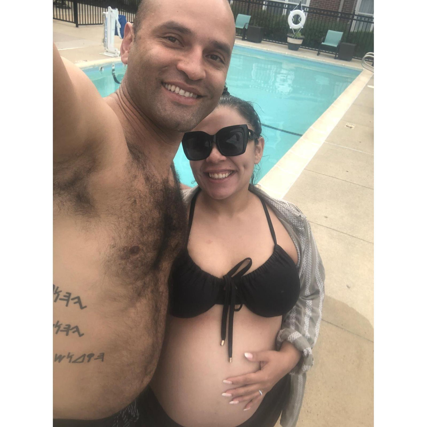 2 soon to be parents cooling off by the pool in Virginia