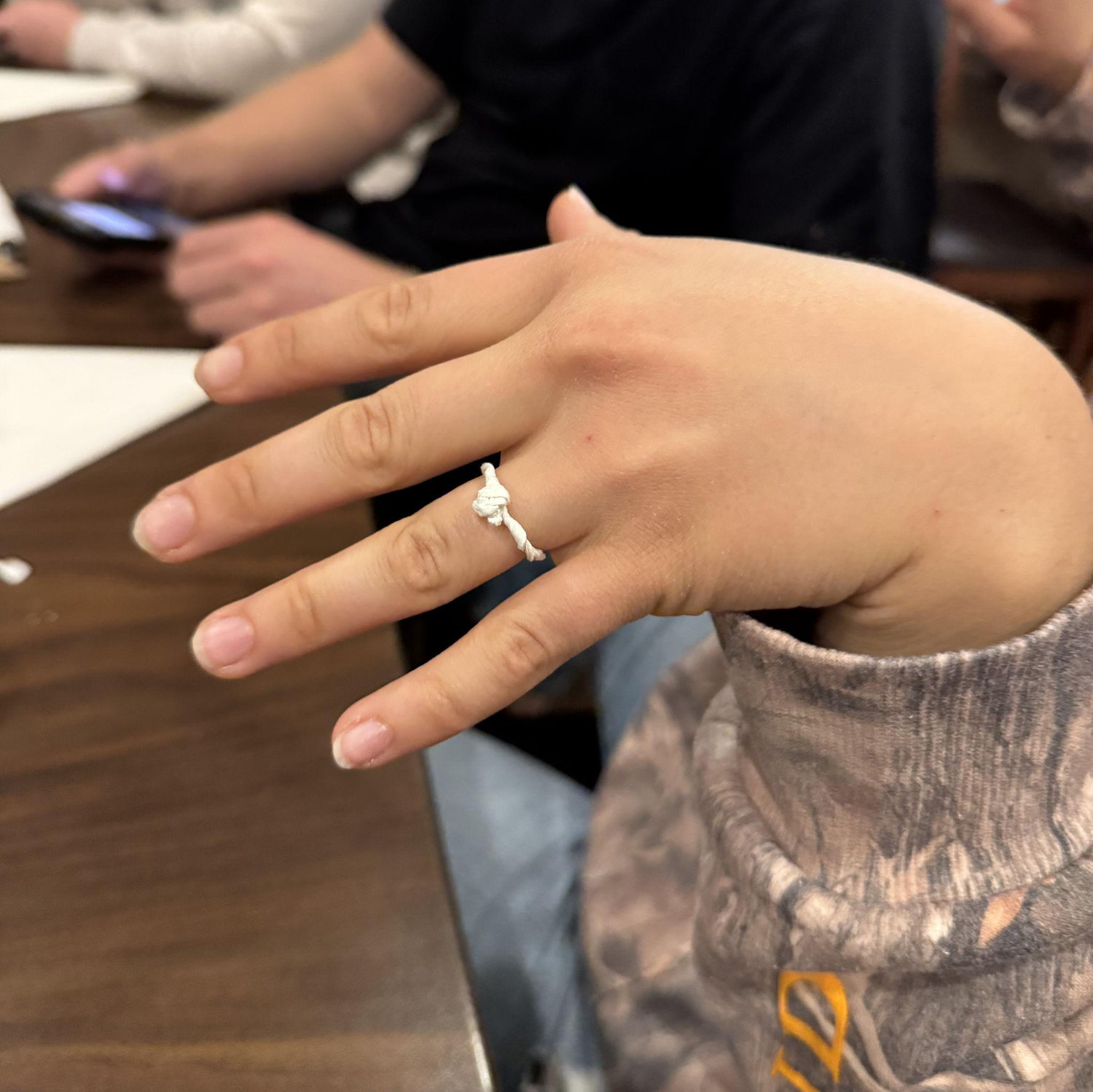 Melody showing Jake how good a ring looks on her finger with a napkin. Little did she know...