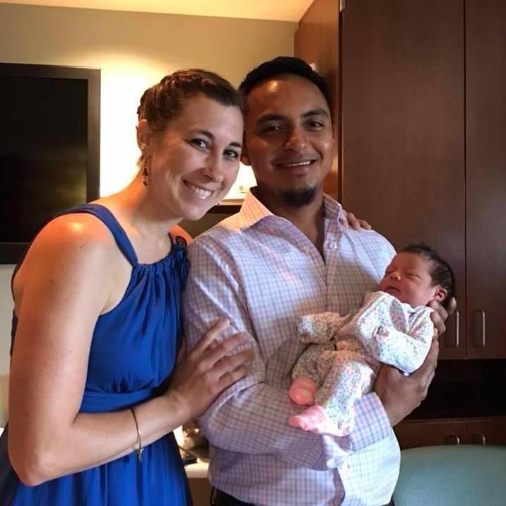 Chris is holding his brand new niece, Aria.
