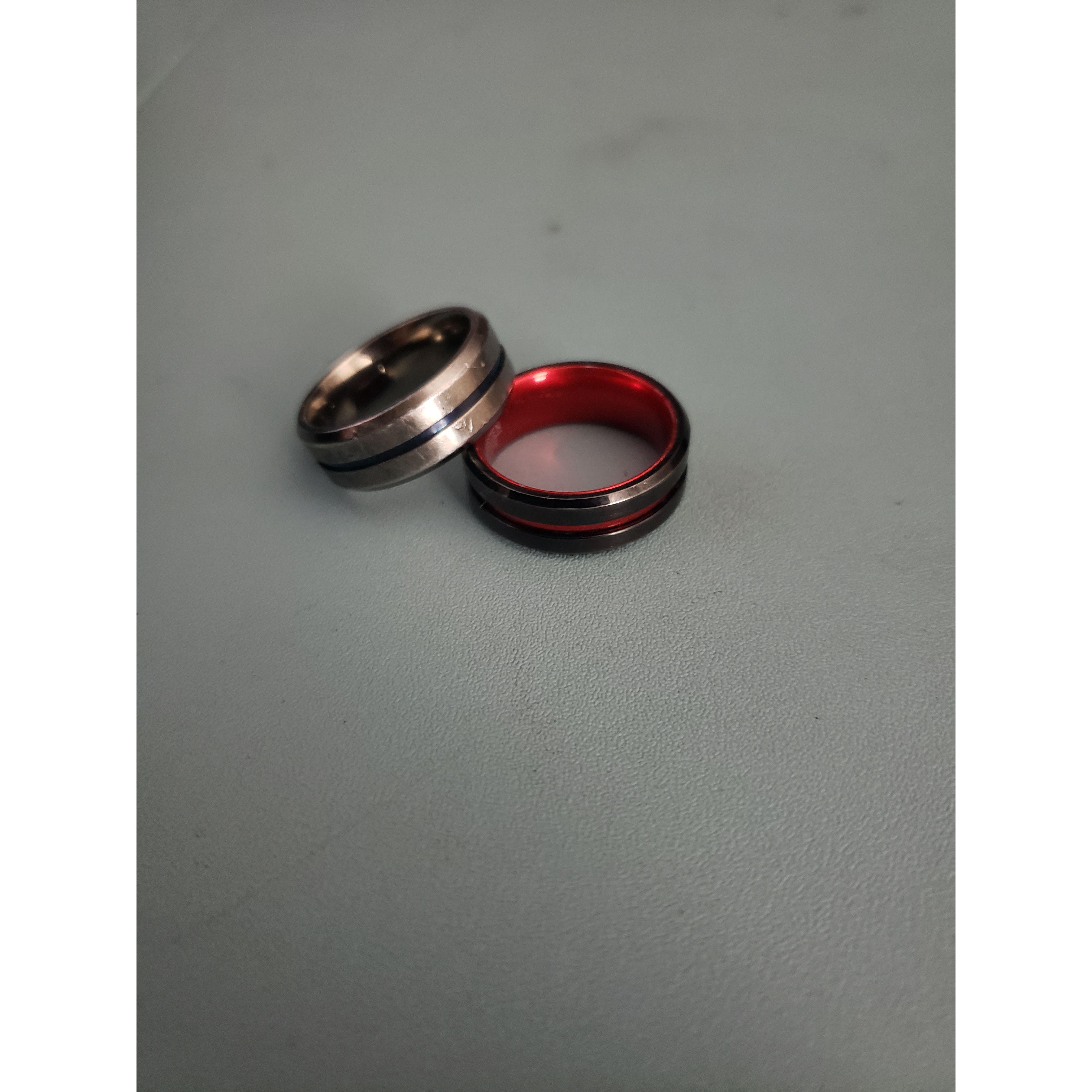 These are our promise rings. The red one is mine for my firefighter husband-to-be, and the blue one is Tyler's for his former officer wife-to-be.