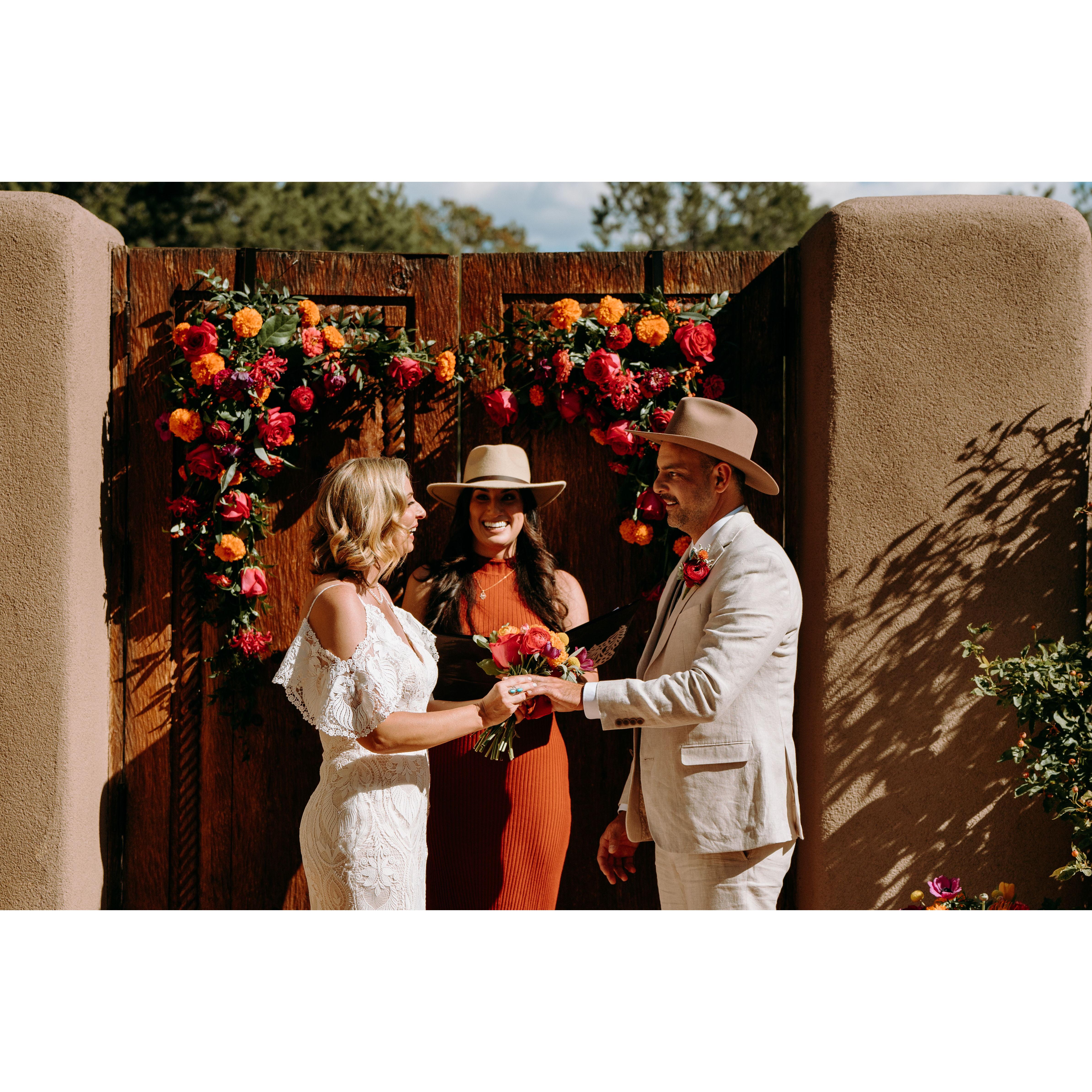 Vow ceremony - Jenn and Shae hold hands as Marie continues the ceremony