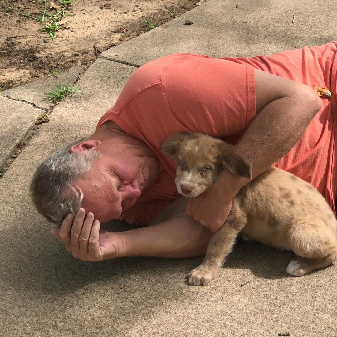 The day we adopted Stan, cuddling with Grumpa  (Jeff)