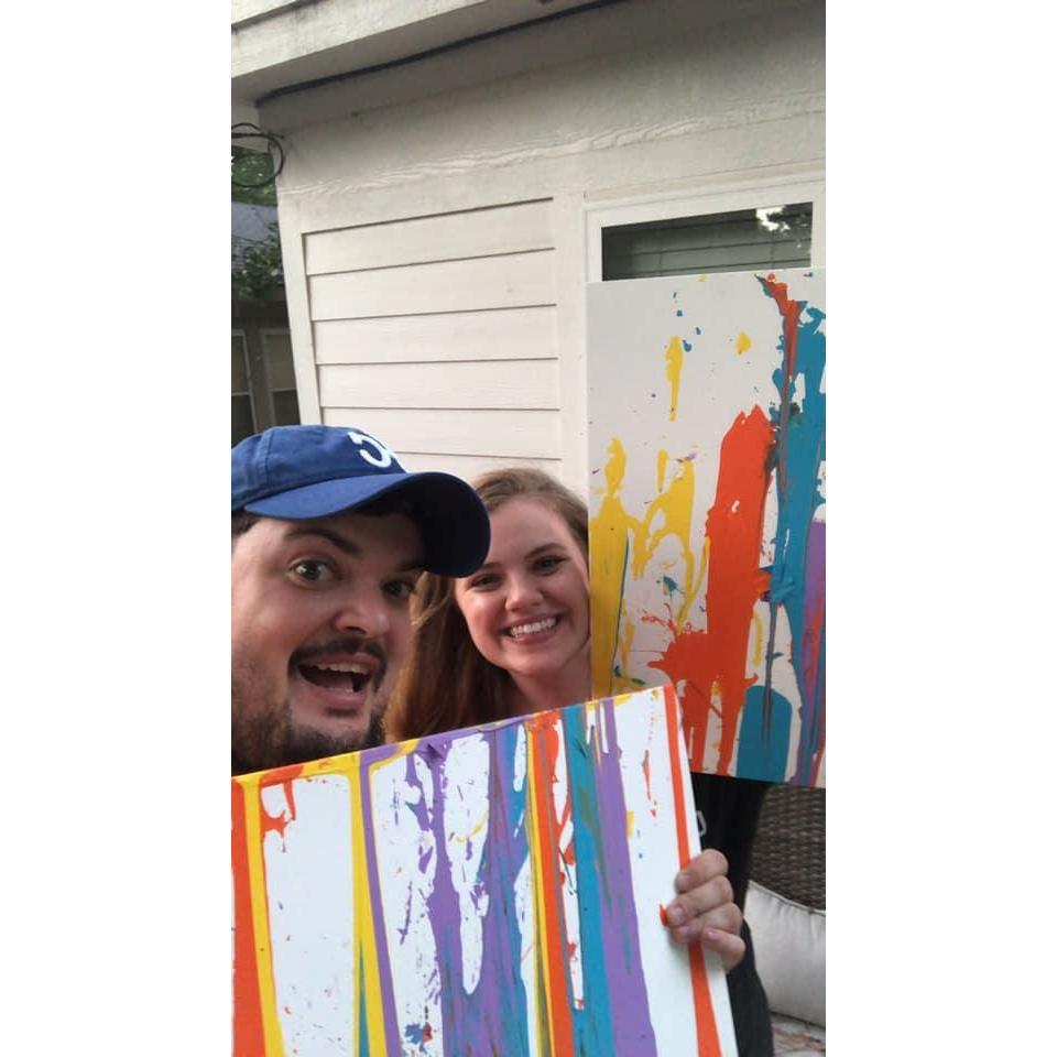This is our first picture together! Taken on our second date. We filled water balloons with paint and threw darts to make some very professional grade art.