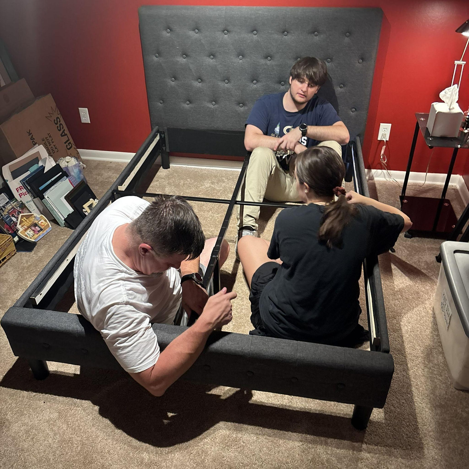 La Famiglia putting a bed together