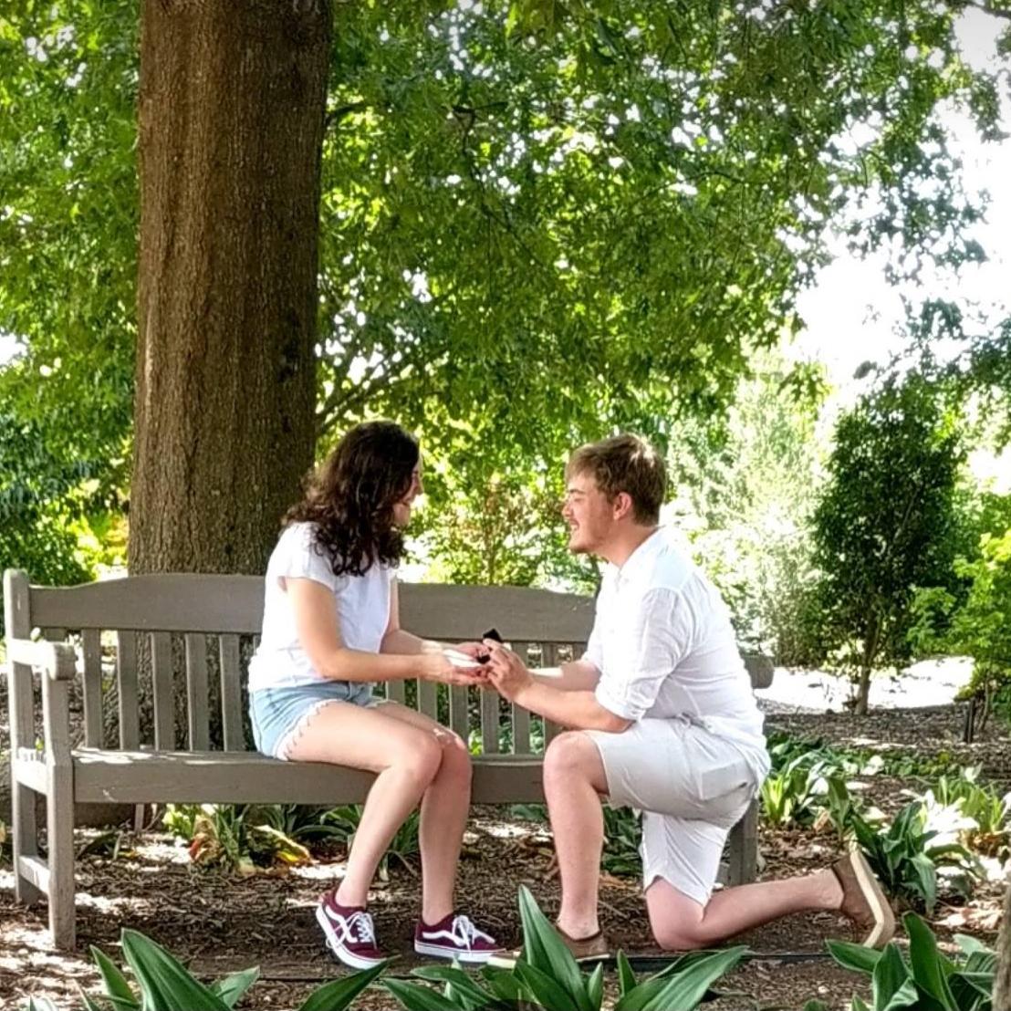 Sam proposing to Stephanie on July 4th, 2018 at the NC State Arboretum.