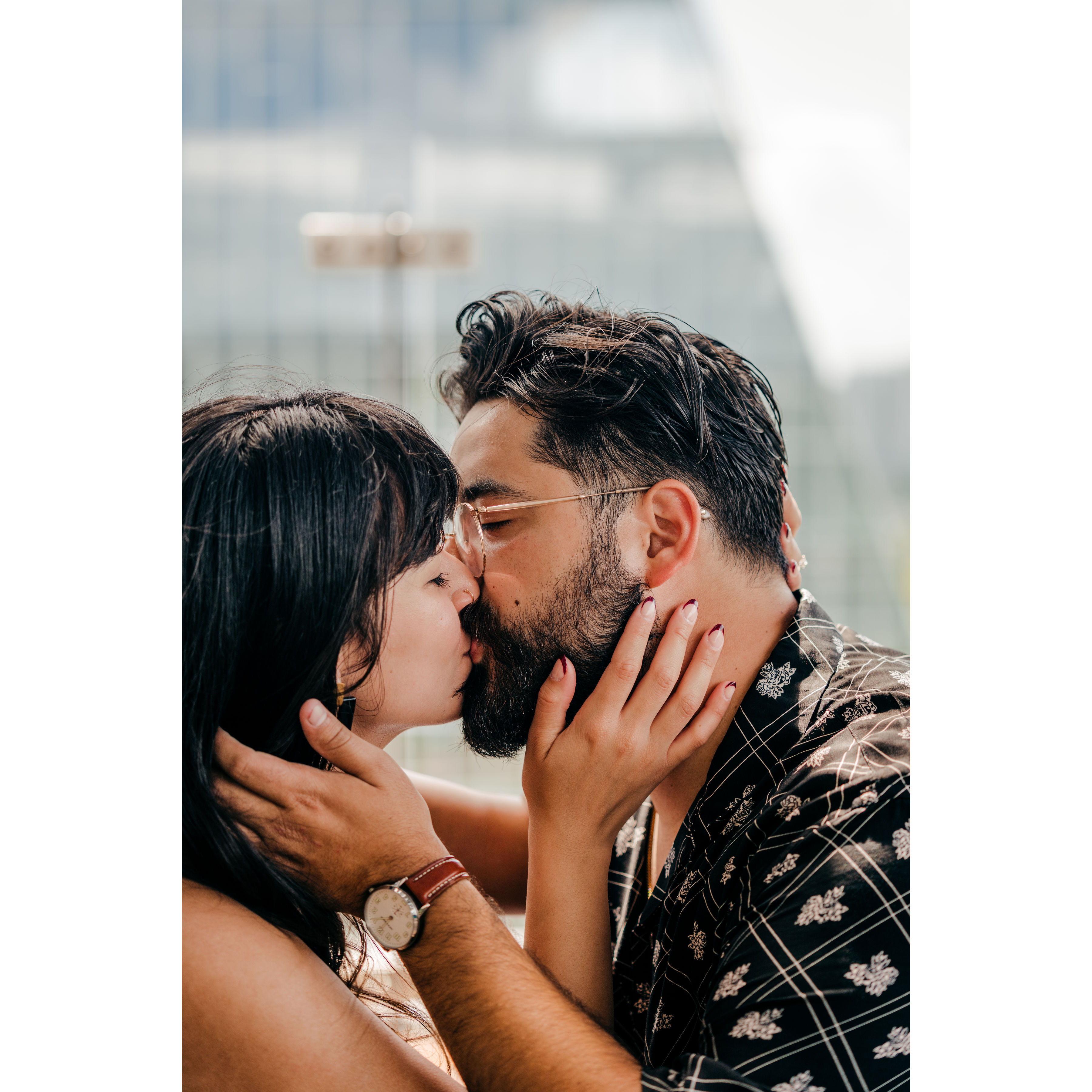 Kieran and Destiny celebrating their engagement with a kiss.