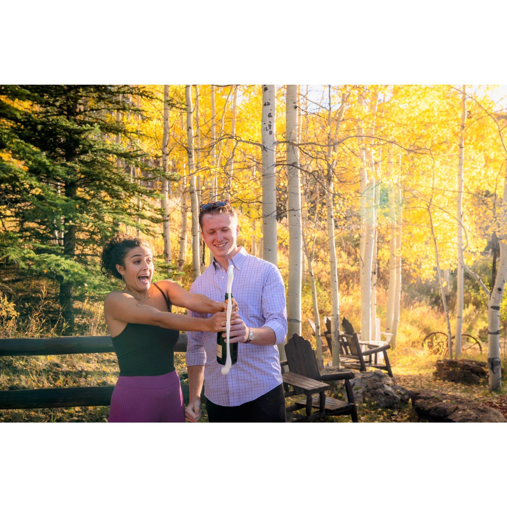 Popping champagne after the proposal!