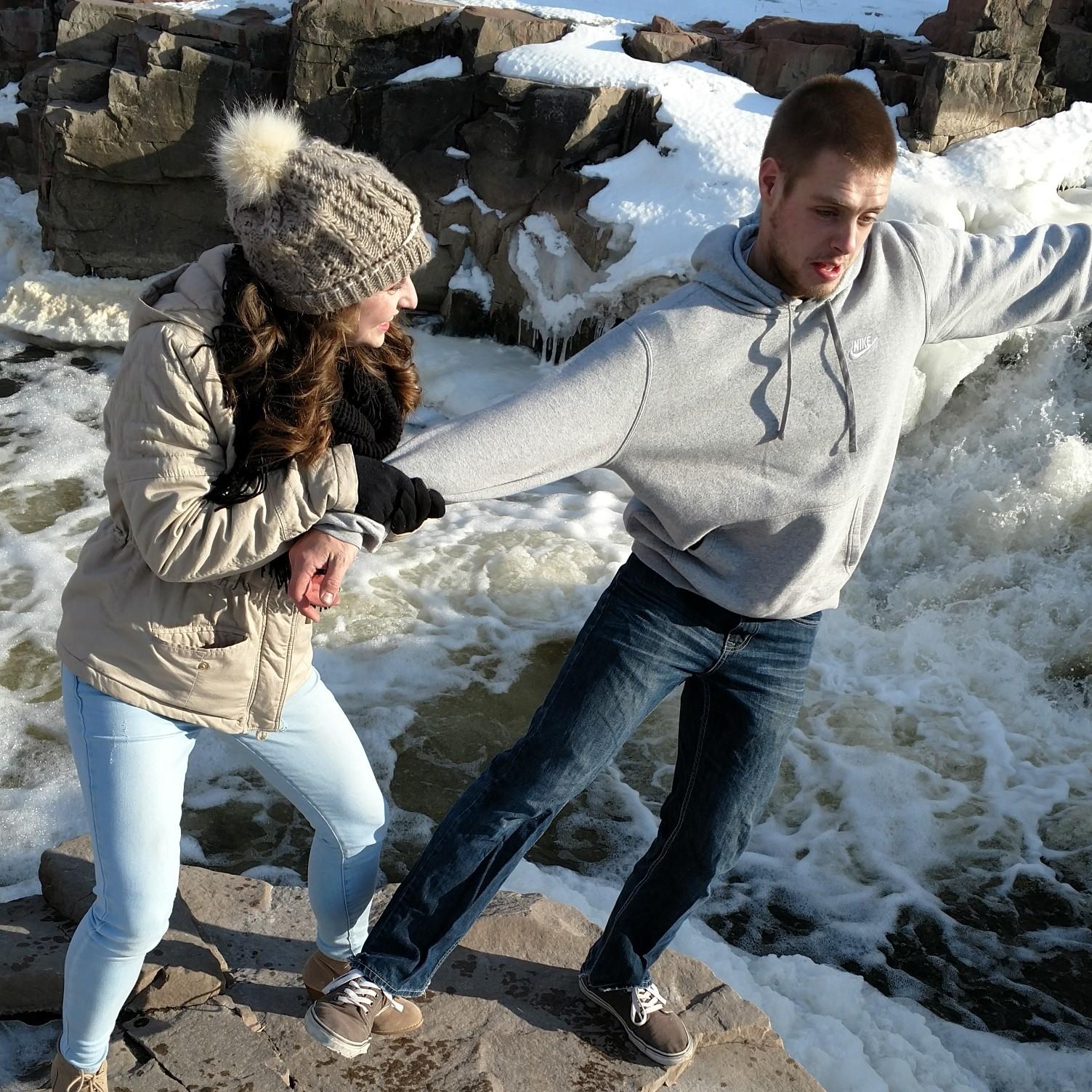 Kimberly pretending to push Bob into the river at the falls.
