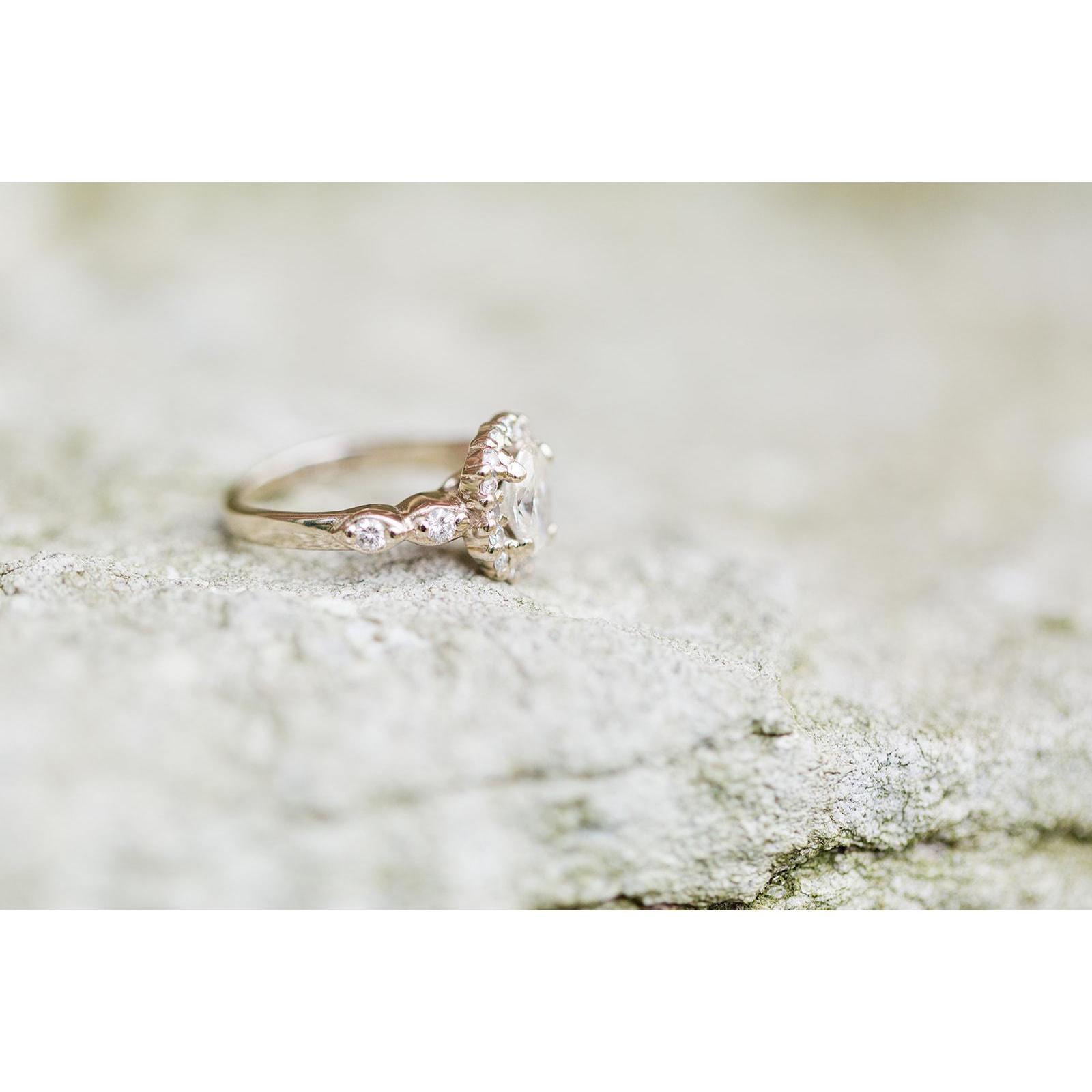 Jay proposed with a gorgeous oval cut diamond in a halo setting with a very special detail; the side stones from his grandmother's engagement ring.
