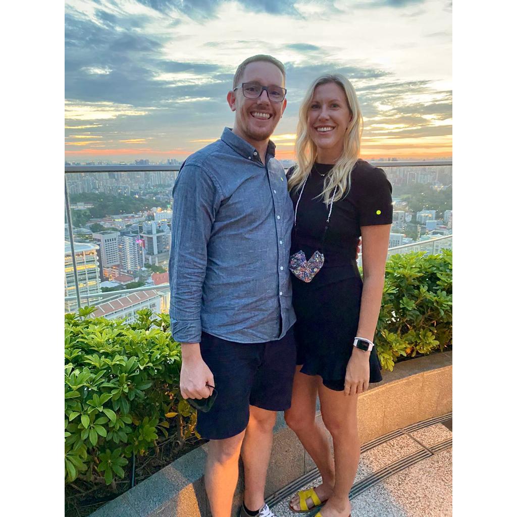 Enjoying the views from a rooftop bar overlooking the Singapore skyline.