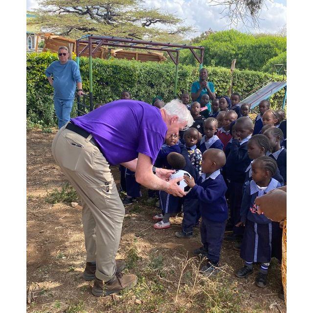 Jim is delivering a soccer ball to one of the schools in Africa