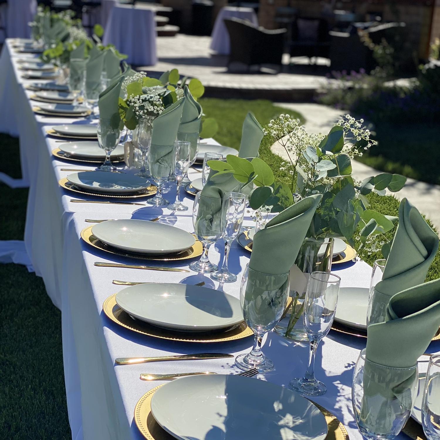 Beautiful outdoor wedding venue with gold and sage green colors
