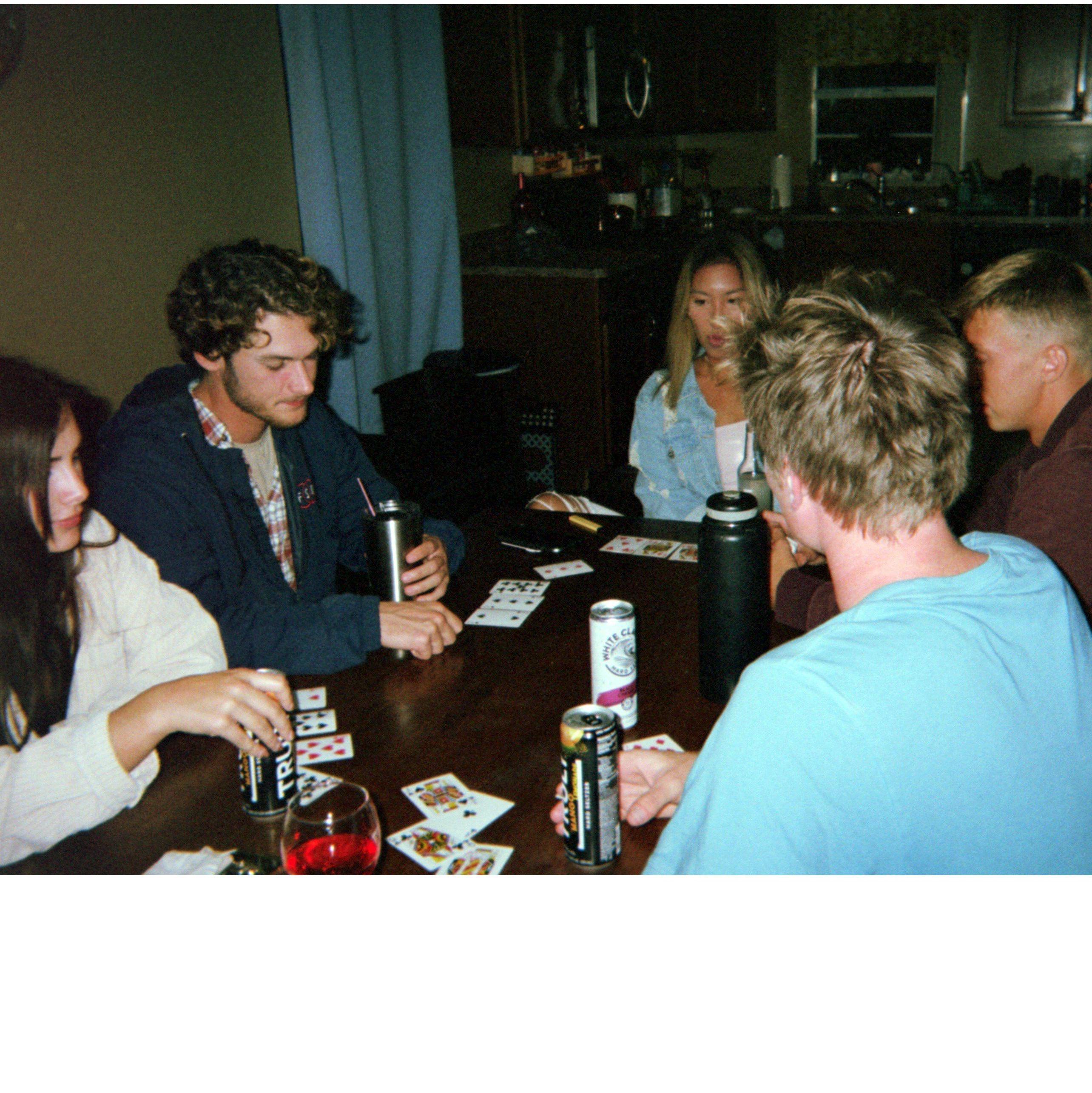 Kaytie, Sean, Loan, Jon, and Wyatt playing cards.