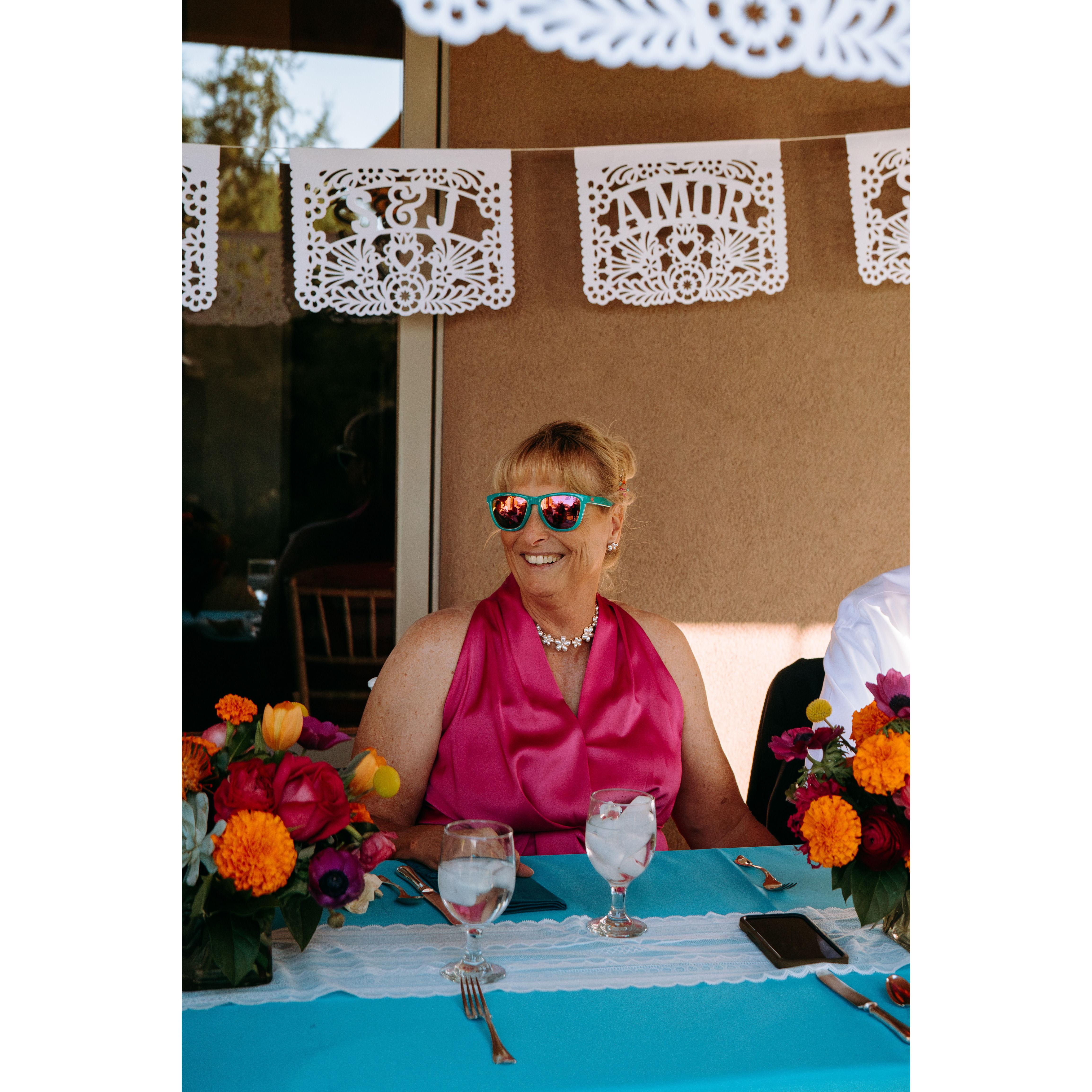 Debi (Jenn's Mom) looks cool with her daughters bright sunglasses on at reception dinner